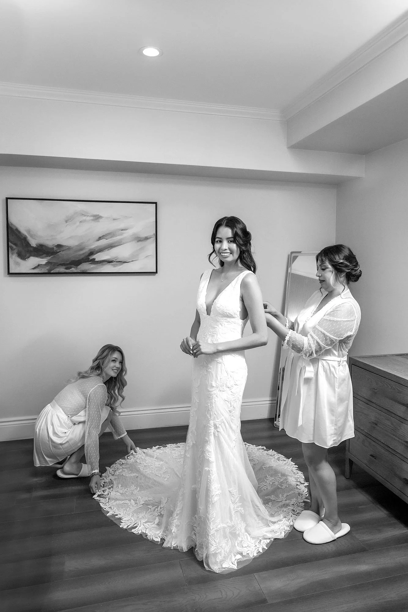 bridesmaids-adjusting-lace-wedding-dress-train.jpg
