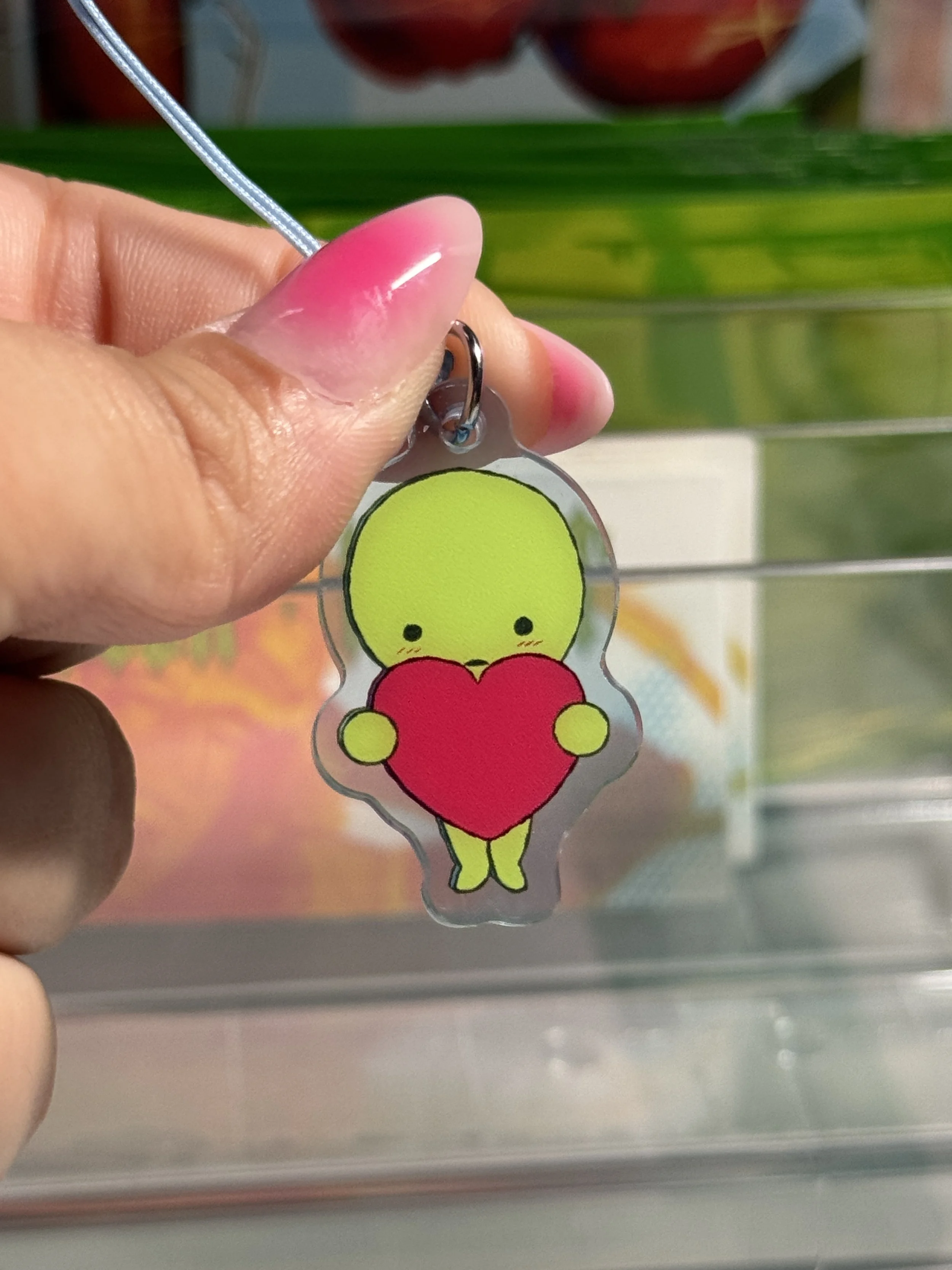 Smiski holding a heart light blue acrylic phone charm!