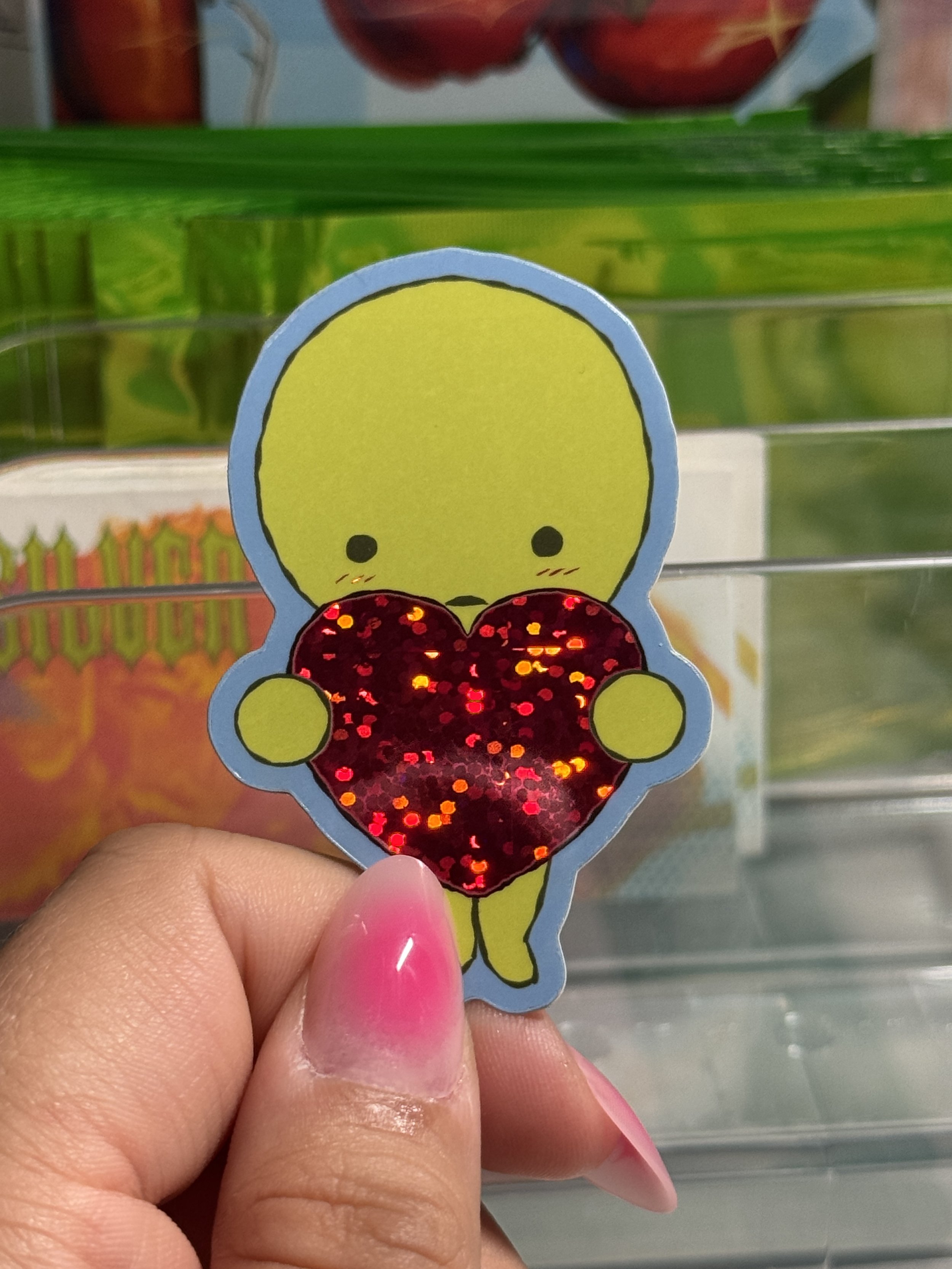 Smiski holding a heart pink glitter sticker!