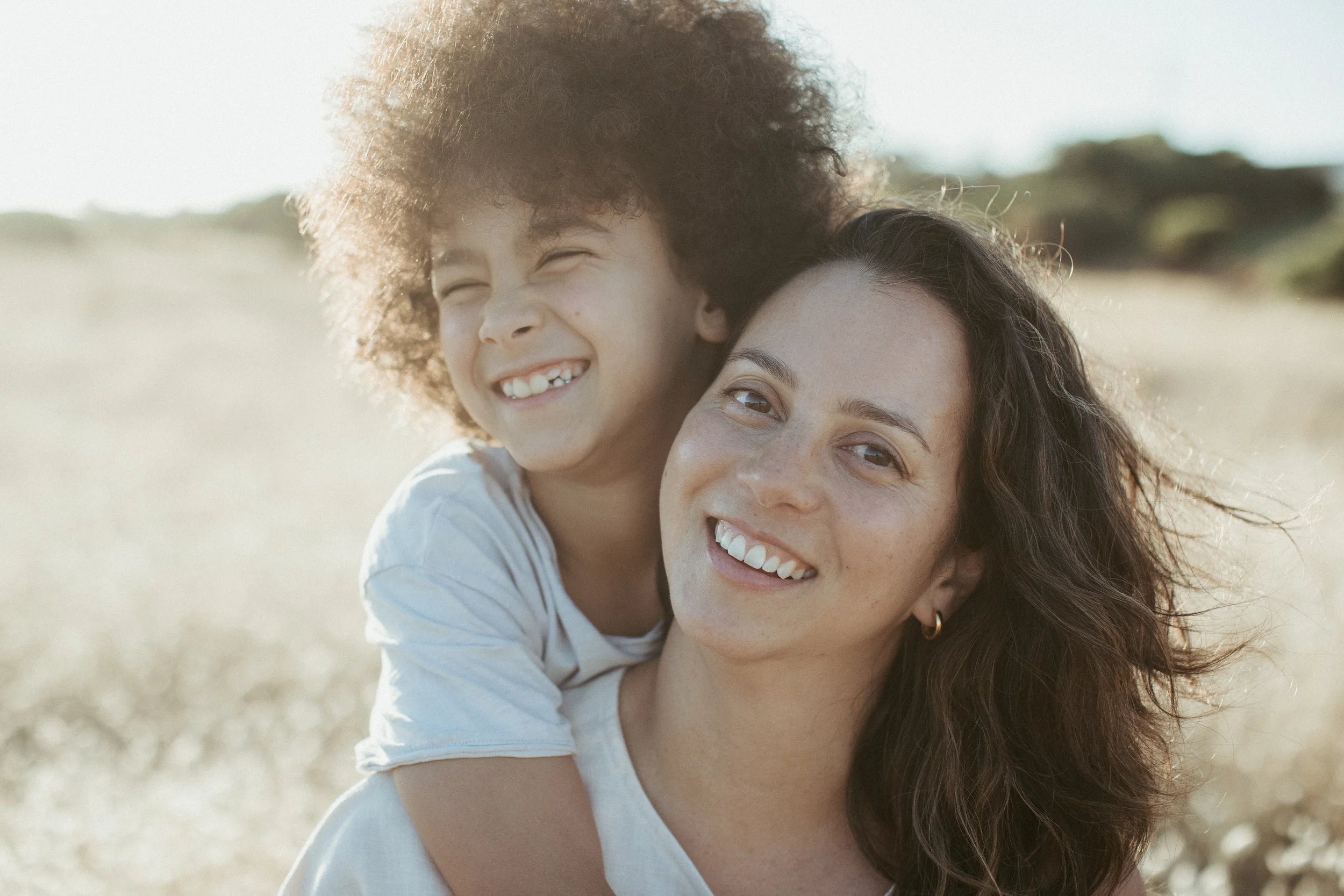 ©Vicky-Hughson-Photography-Mother-Son-Field-Hug.webp