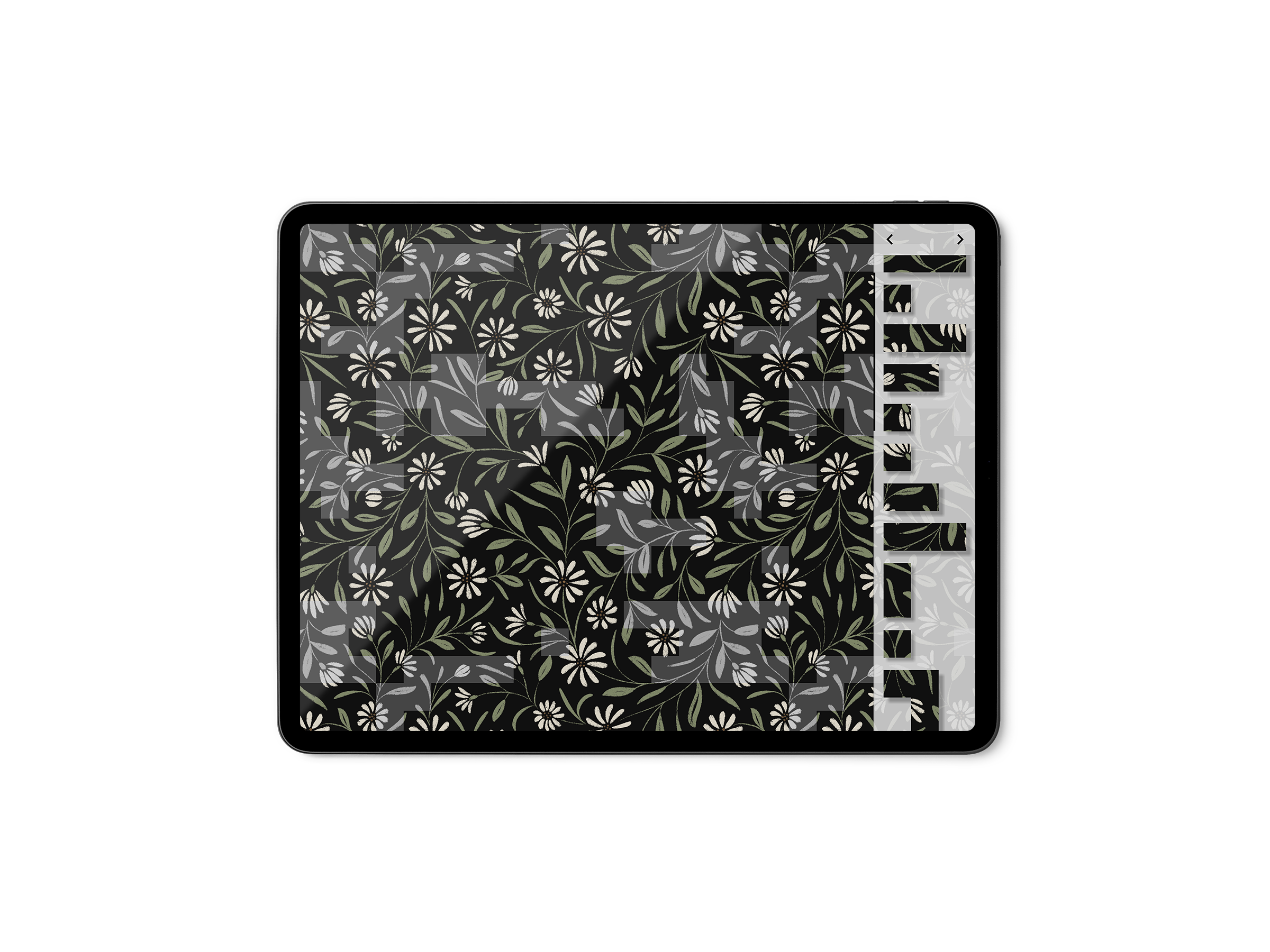 Close-up of a digital tablet displaying a floral pattern with white flowers and green leaves on a black background, with editing tools visible on the right side.