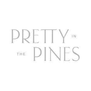 Text that reads 'PRETTY IN THE PINES' on a white background