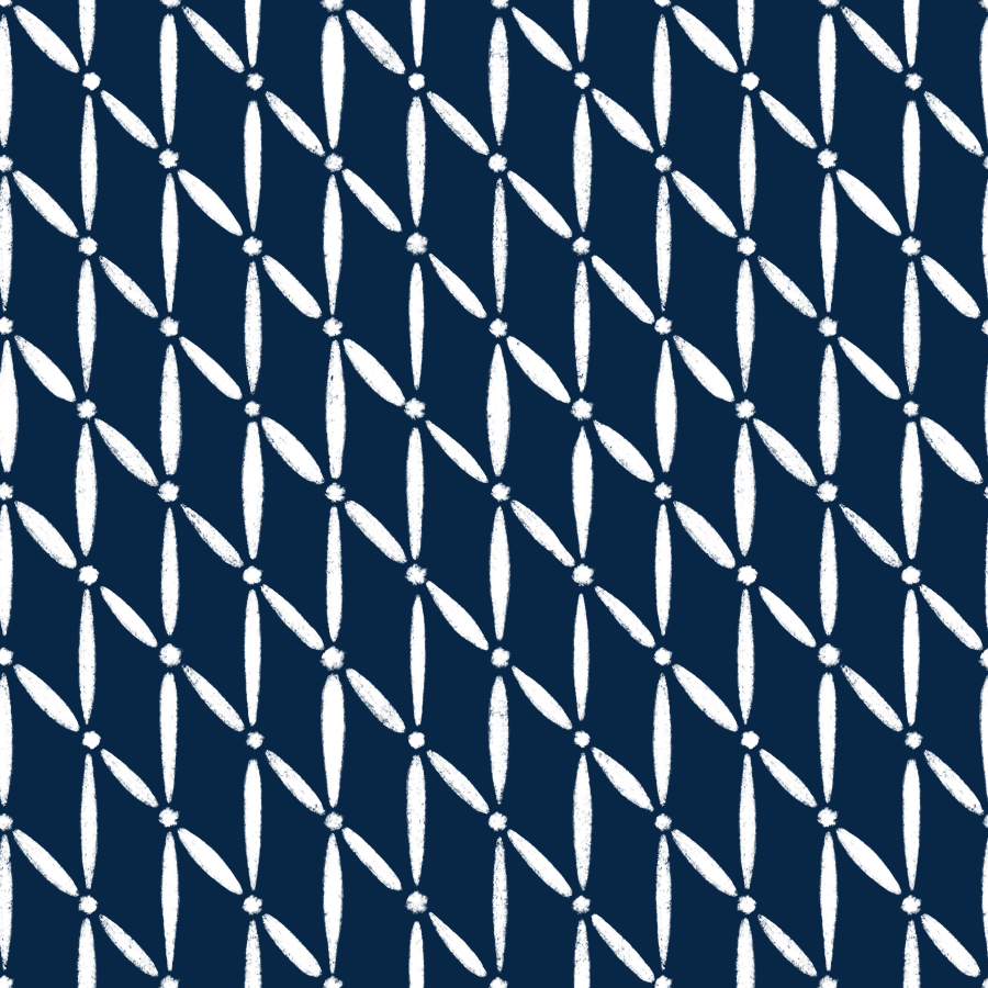 Pattern of white embroidered geometric shapes on a dark blue fabric background.