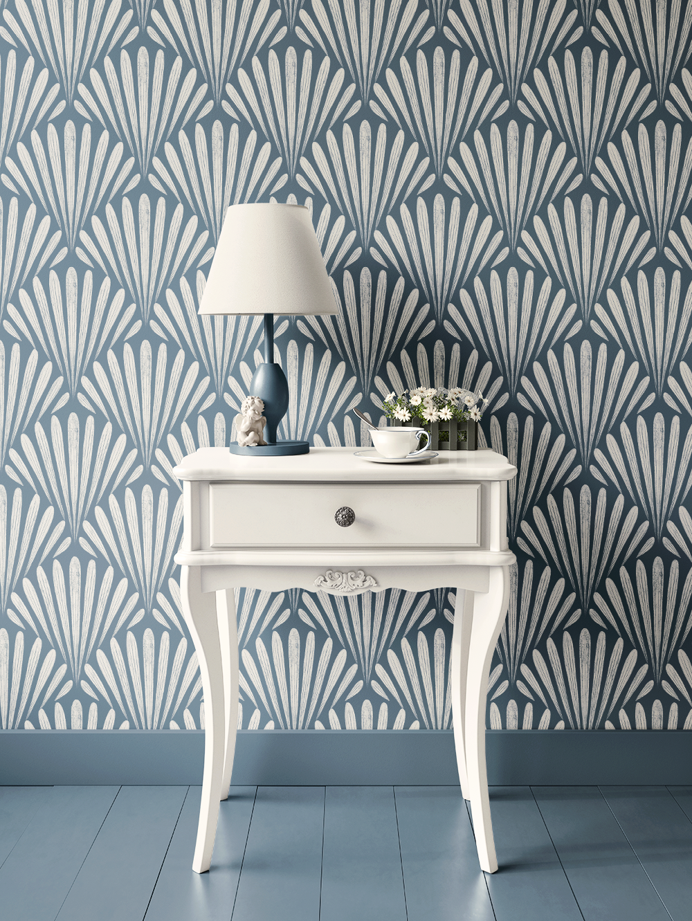 A white vintage-style table with curved legs against a blue and white patterned wall, topped with a blue lamp, a small sculpture, a cup and saucer, and a small bouquet of flowers.