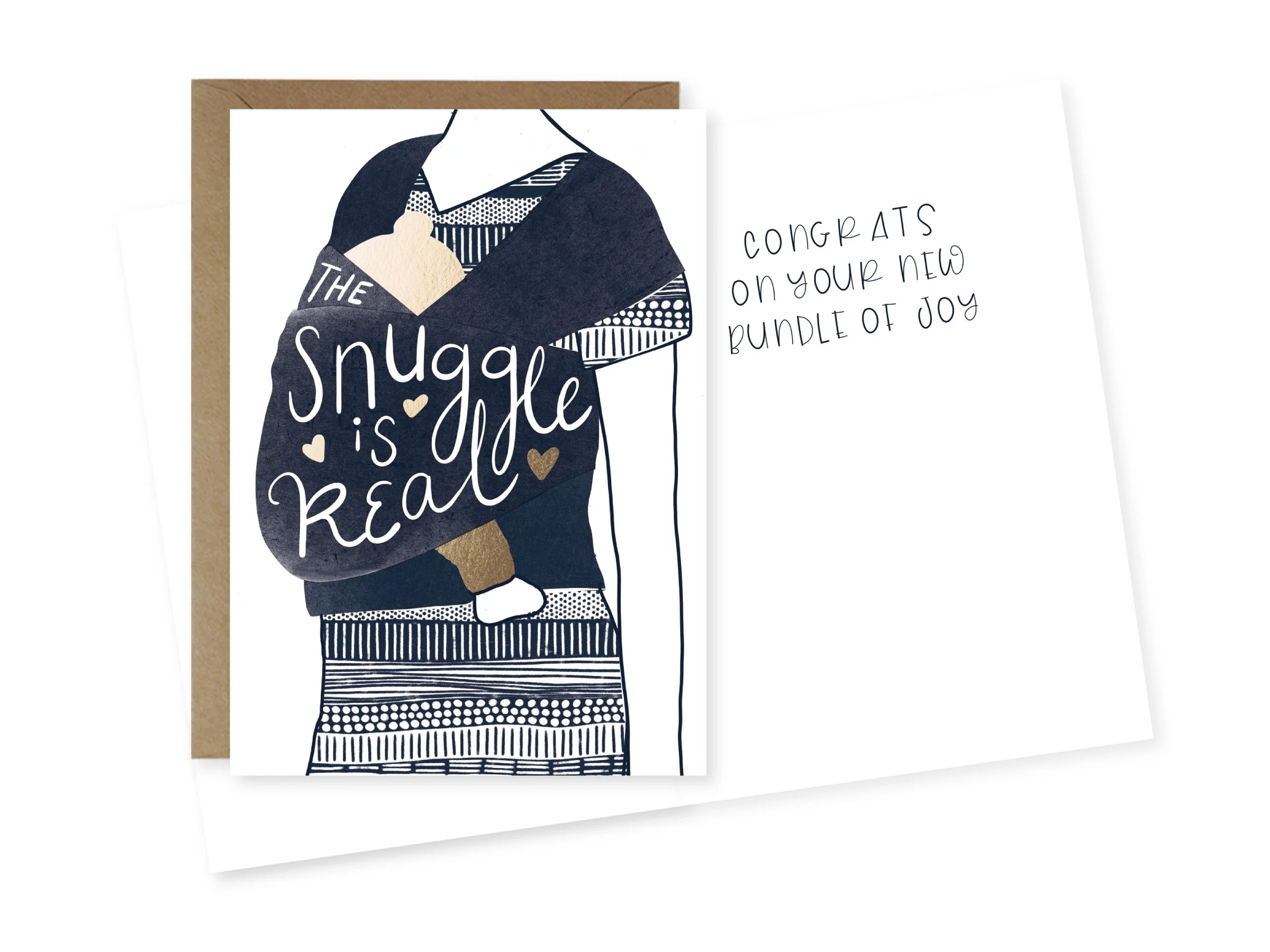A greeting card with navy blue and gold accents featuring a stylized illustration of a person holding a gift. The card says, "The Snuggle is real," and the inside of the card has the handwritten message, "congrats on your new bundle of joy."