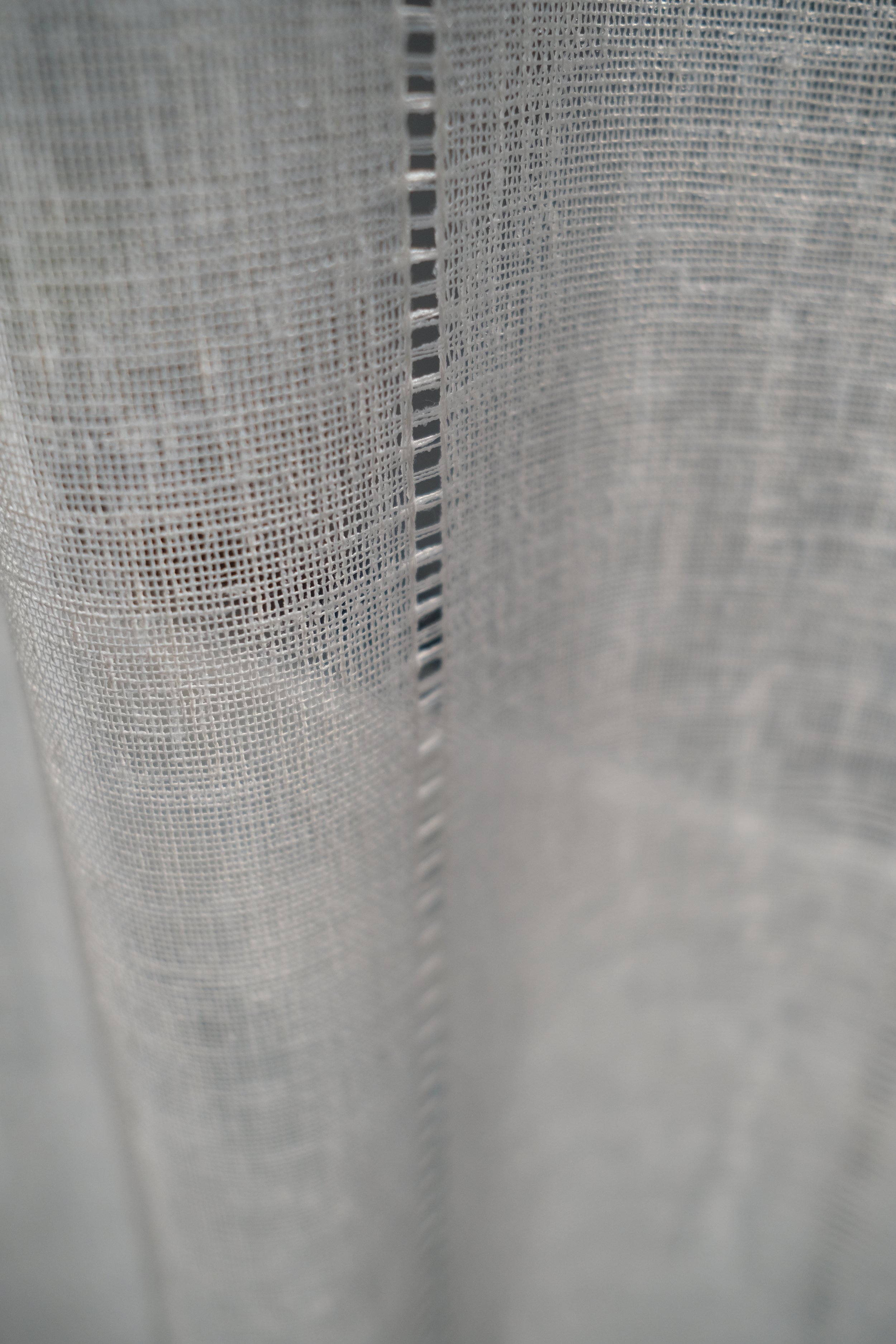 Soft cotton and linen ivory sheer curtains creating layers in the room and bringing soft atmosphere and light filtering