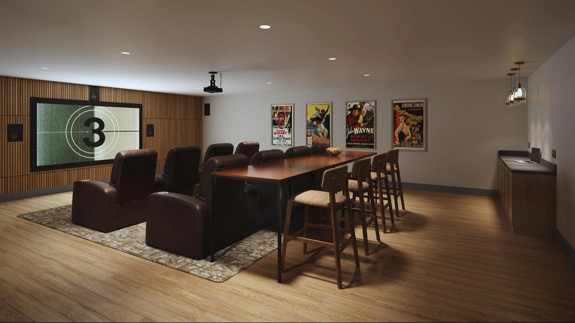 Move theater room with a movie screen at Mill Miss apartments, comfortable chairs, a long table with bar stools, vintage movie posters on the wall, and a small workspace with a tablet.