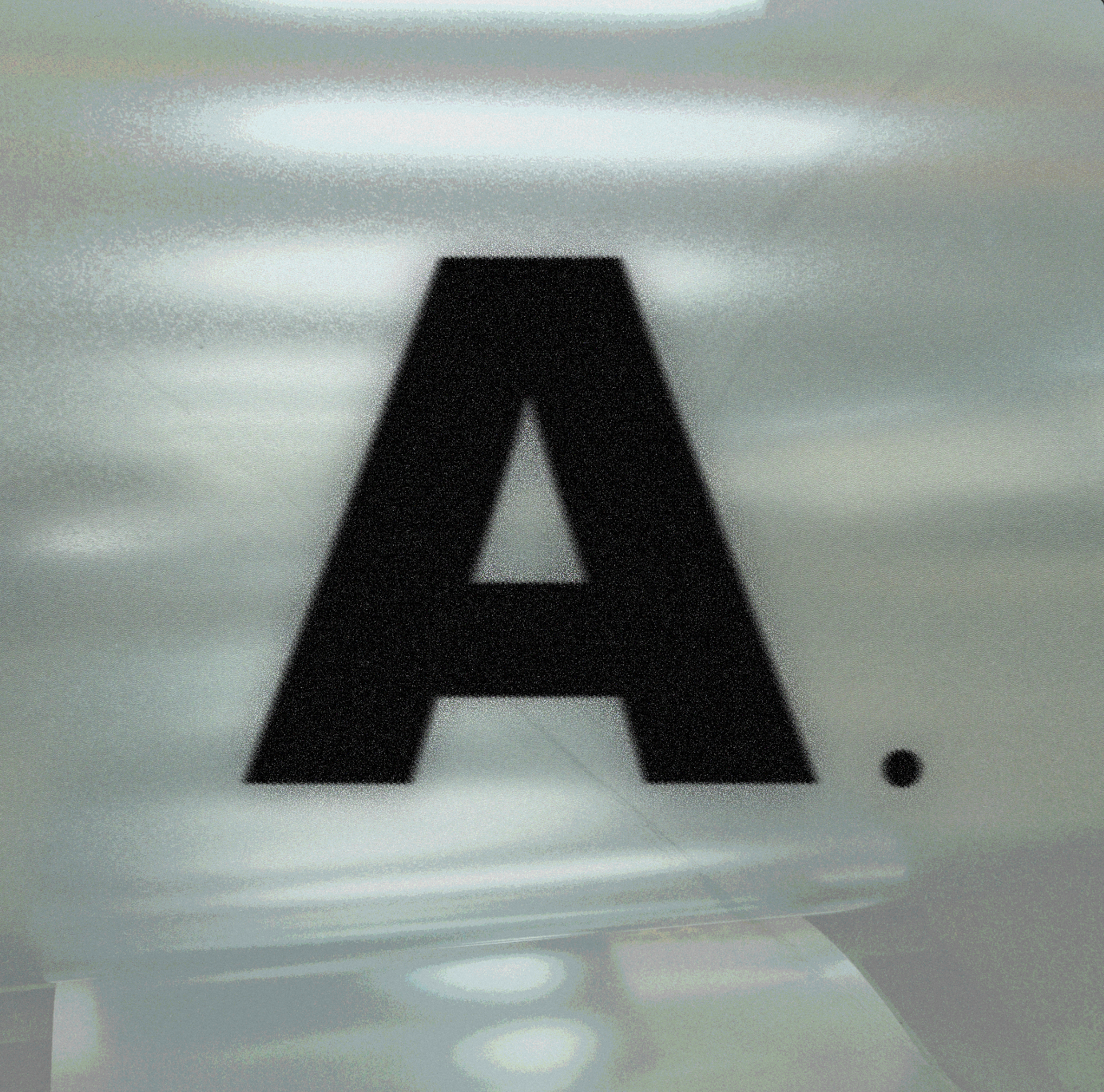 A large black letter A printed on a white surface with a period next to it.