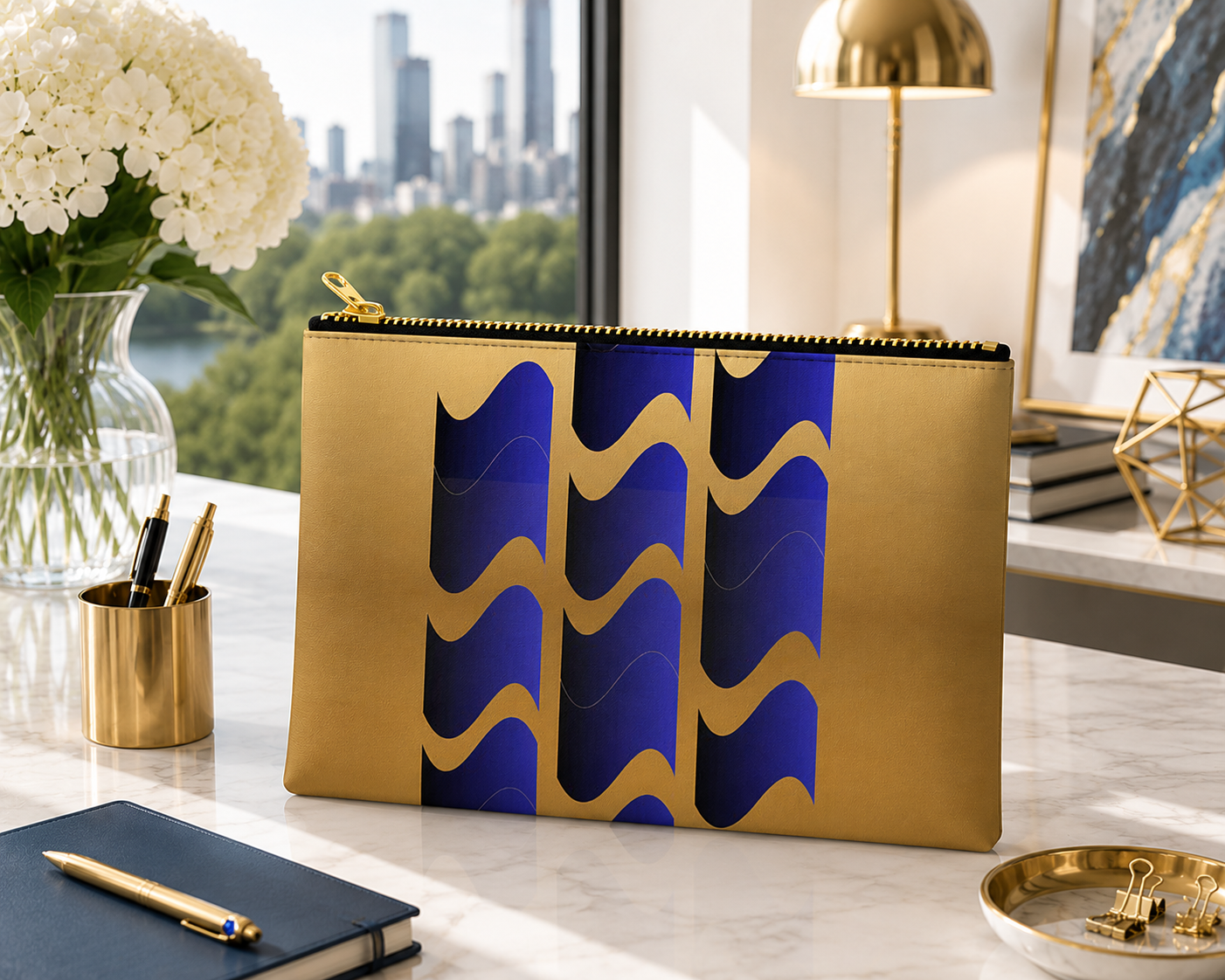 Modern zip pouch featuring abstract navy blue and gold geometric waves displayed on a bright luxury desk with elegant contemporary décor.
