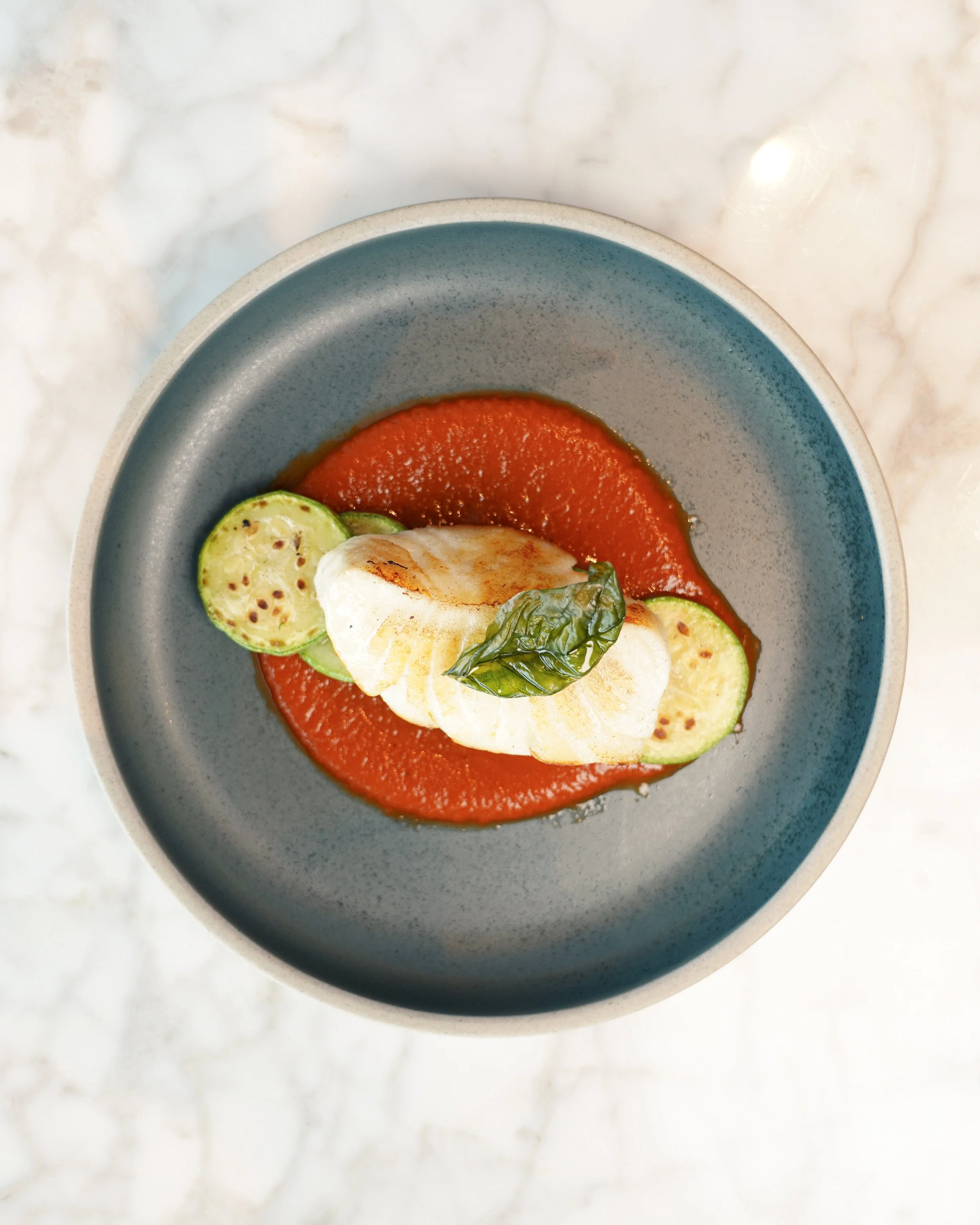 Contemporary Italian Main Course with Seared Fillet, Grilled Zucchini, and Tomato Coulis at Dedica IFC Central
