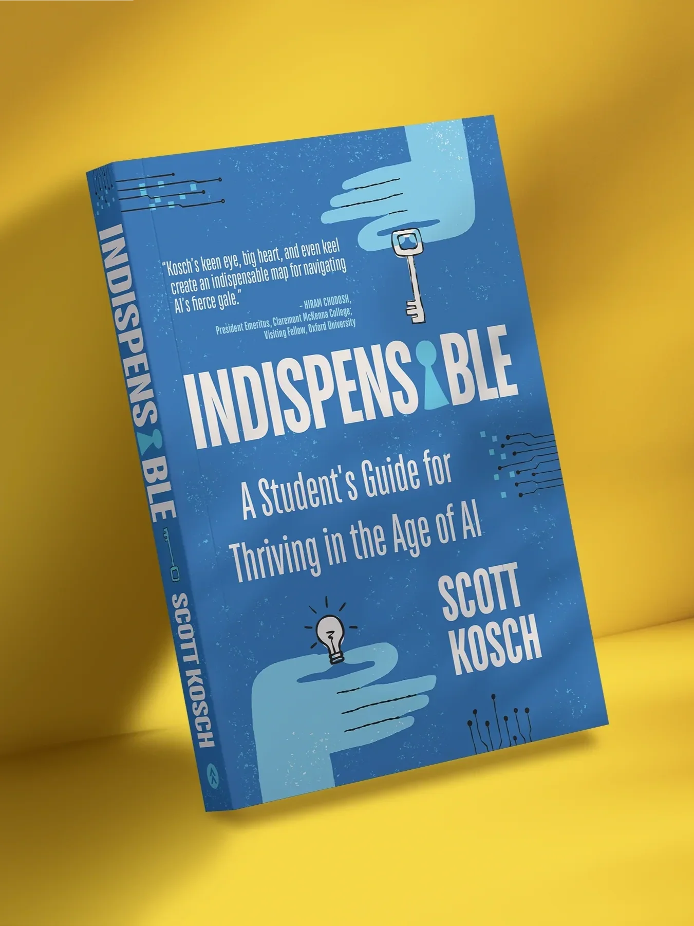 A blue book titled "Indispensable" with a subtitle "A Student's Guide for Thriving in the Age of AI". The cover features an illustration of a hand holding a key, with circuit-like patterns and a small light bulb icon.