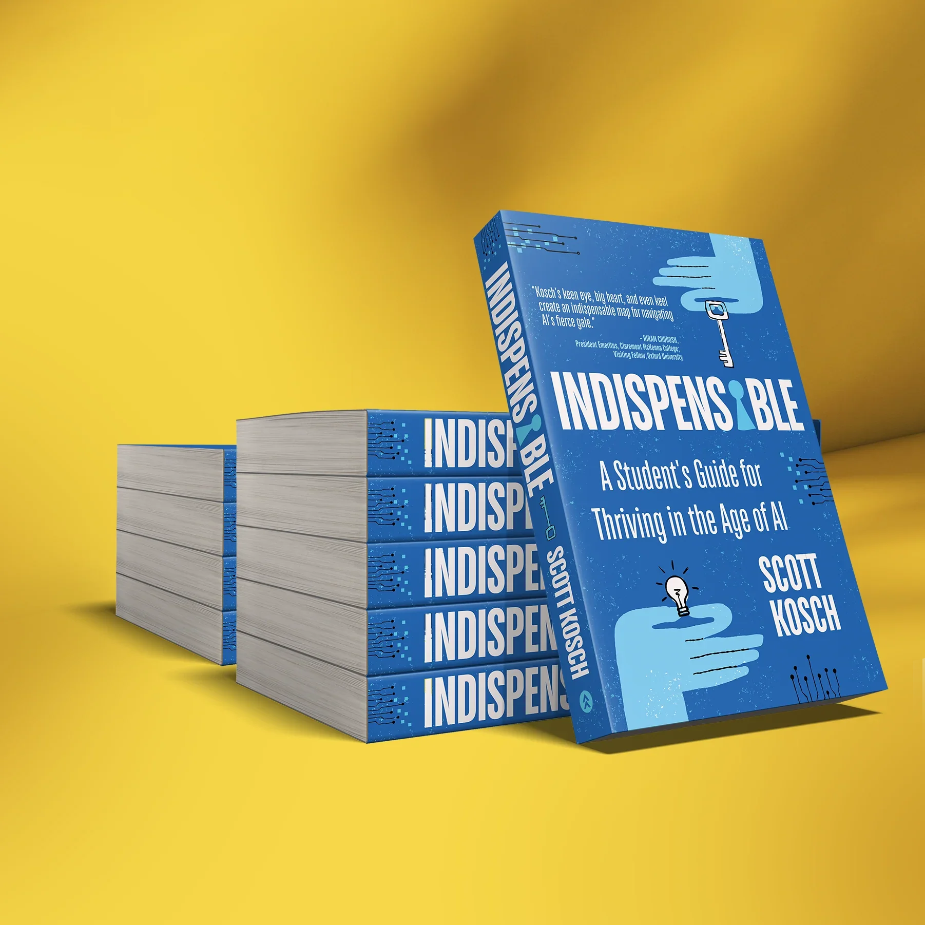 Many copies of a blue book titled "Indispensable" with a subtitle "A Student's Guide for Thriving in the Age of AI" stacked on a yellow surface with a yellow background. The cover features an illustration of a hand holding a key and a quote about AI.