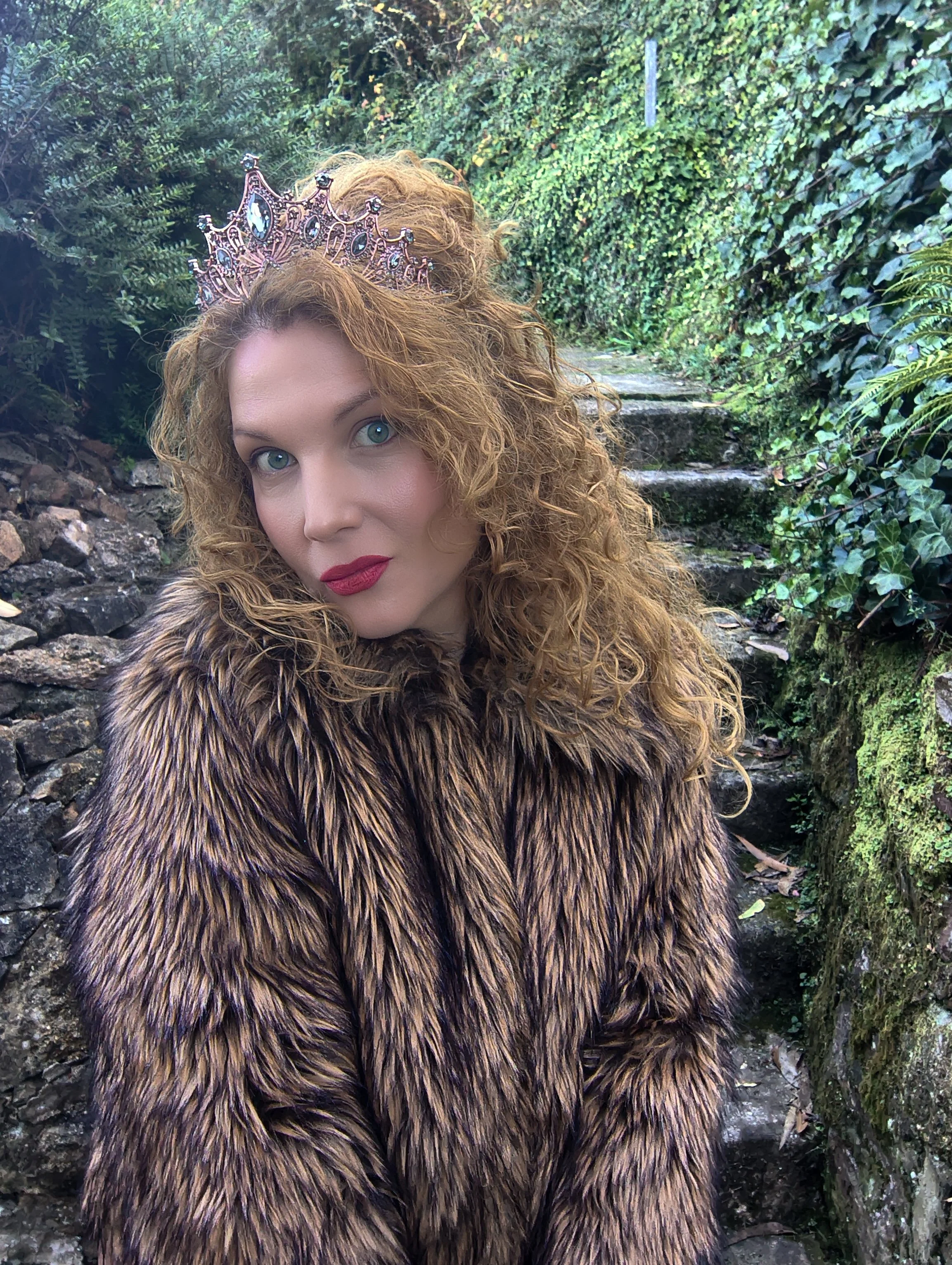 portrait of woman with tiara wearing a furry coat