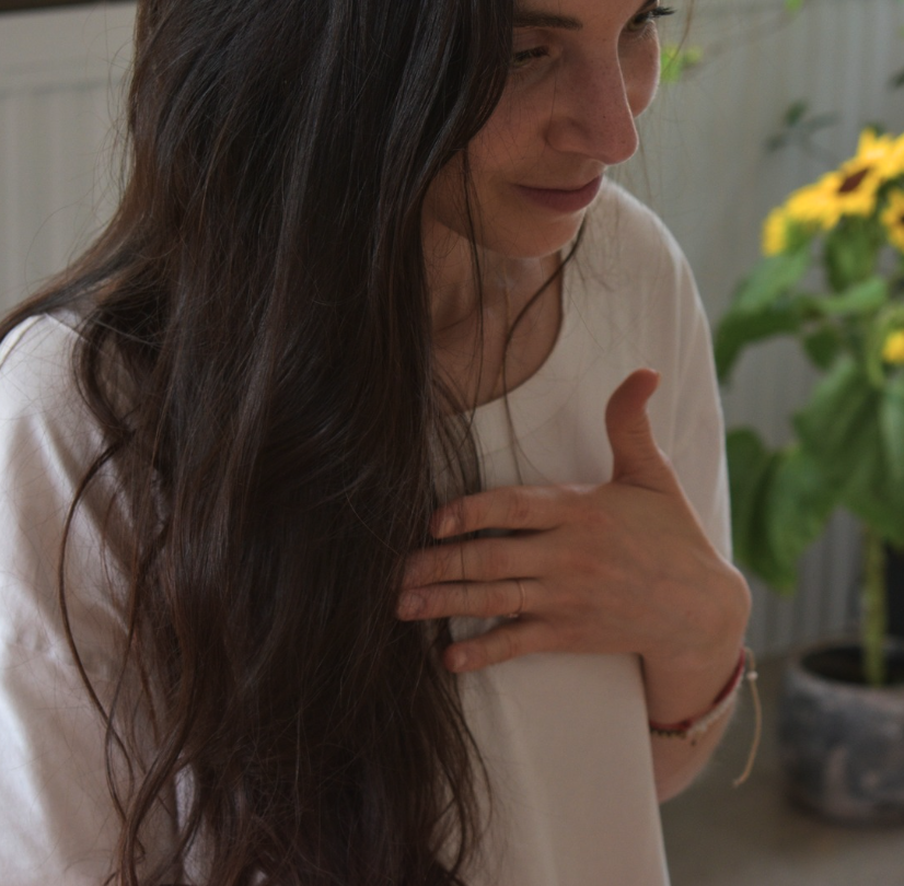 Maëva, main posée sur le cœur, un geste d'ancrage et de gratitude
