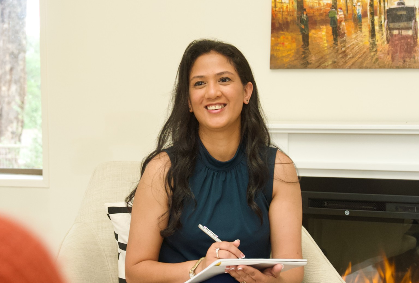 Annabelle Cangy, NLP and Neuro-Semantic coach at Get Unstuck Coaching, sitting with a notebook in a calm coaching environmen