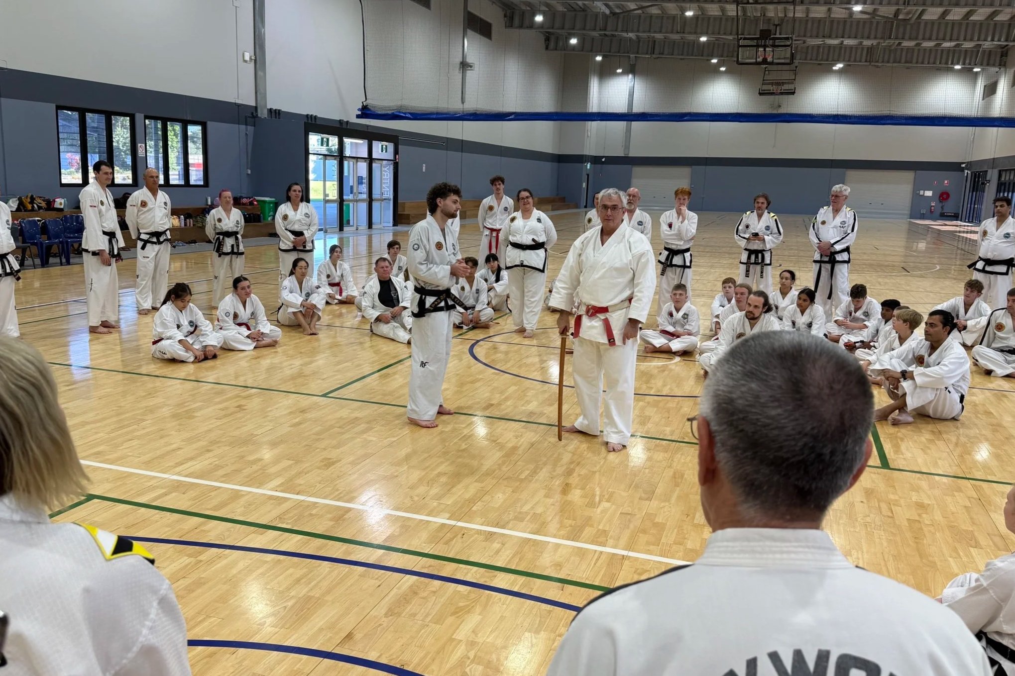Ross Cameron leading a martial arts seminar for instructors and students at a host club.