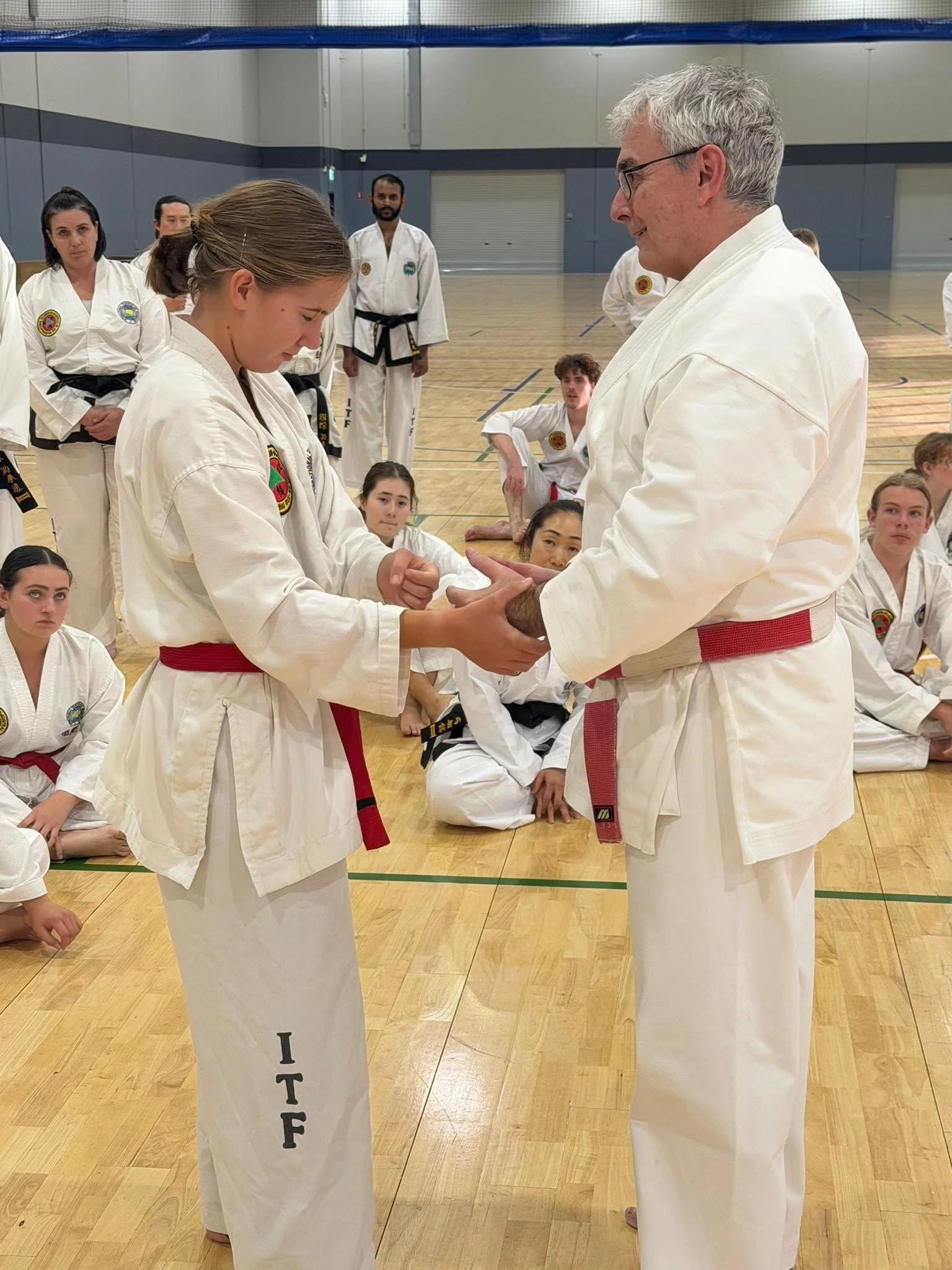 Ross Cameron mentoring a young martial arts student during a grading and instructor development seminar.