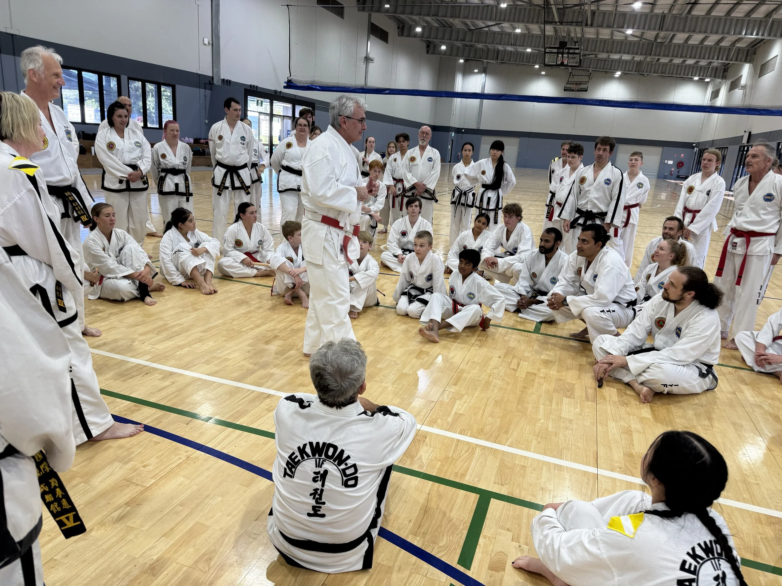 Ross Cameron leading a martial arts seminar with instructors and students during a practical training session.