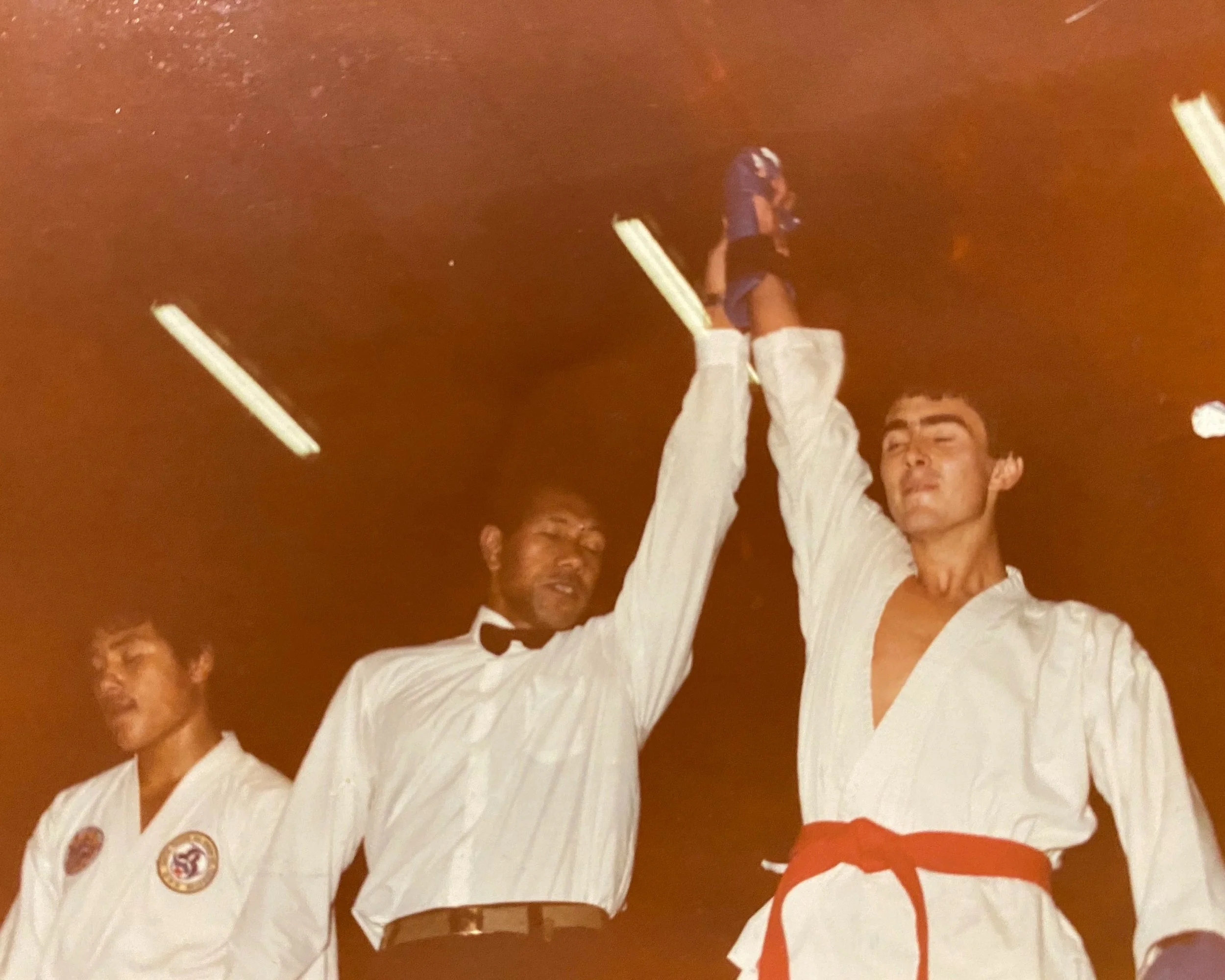 Ross Cameron having his hand raised after a martial arts competition victory.