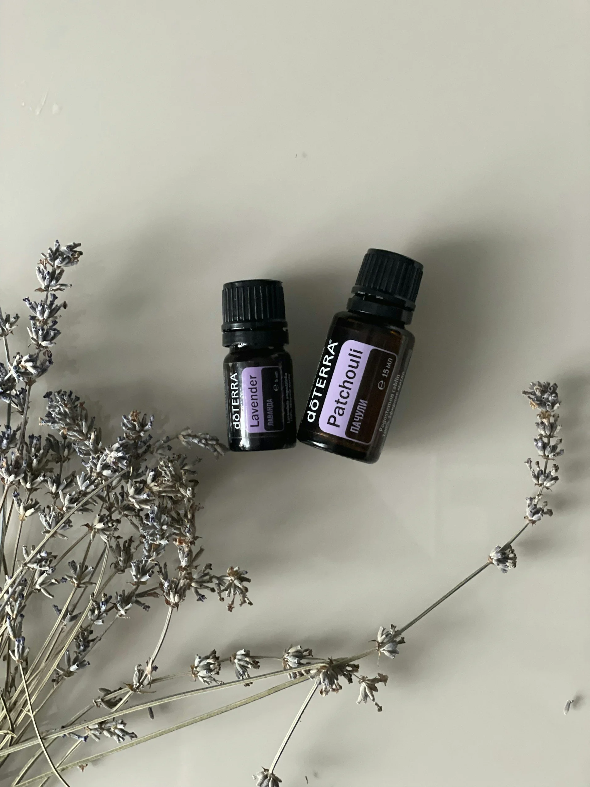 Lavender and Patchouli essential oil bottles with dried lavender flowers.