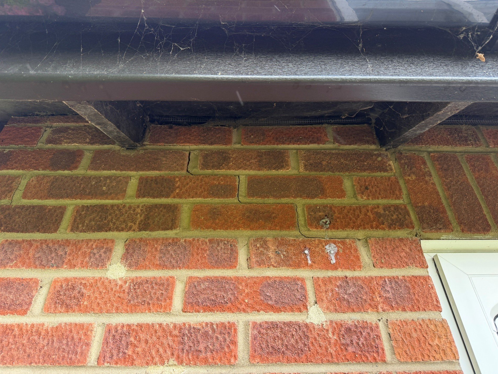 Image of brick wall on a house showing cracks in the brickwork
