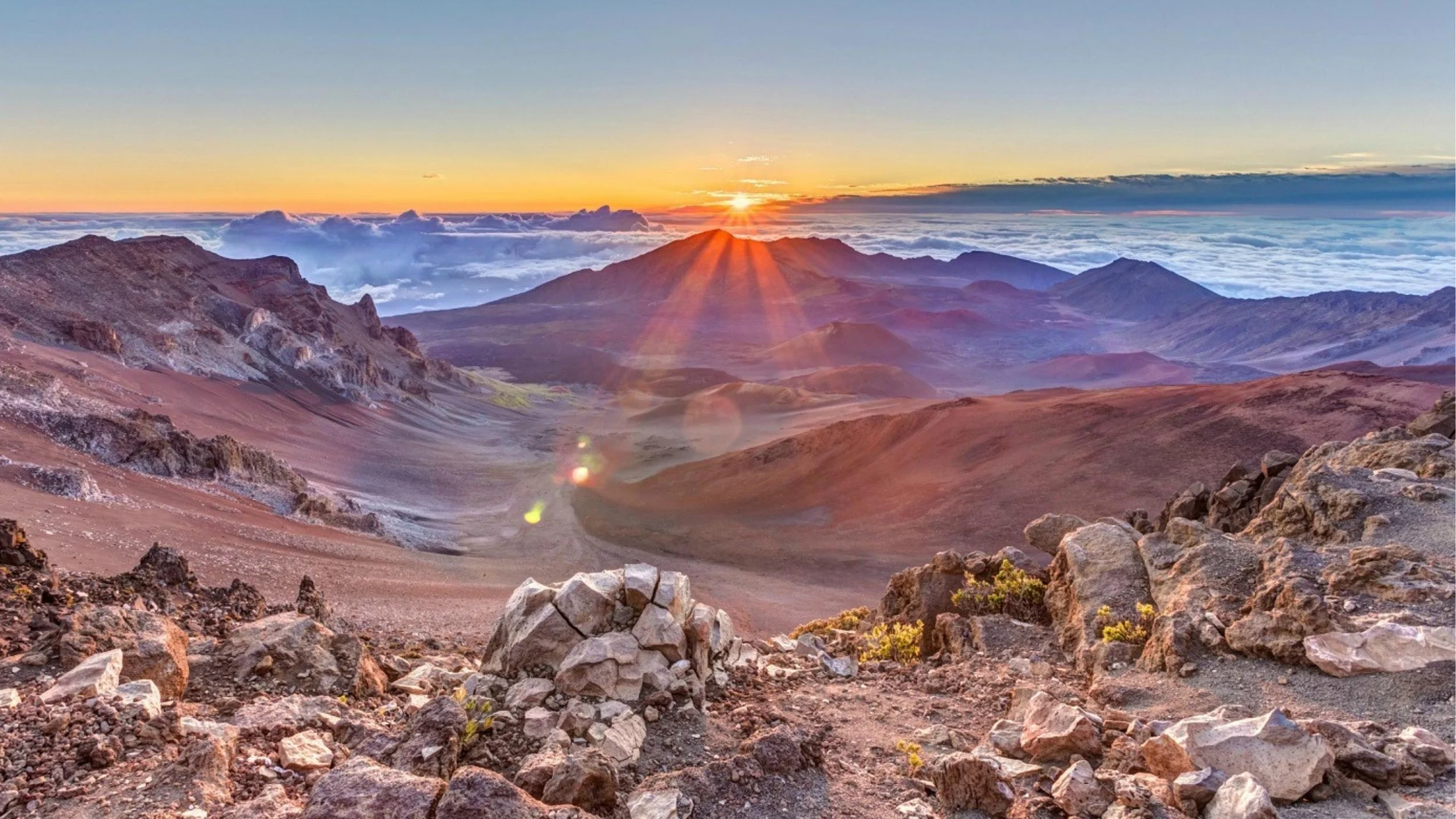 Gorgeous sunset above clouds Haleakala volcano Maui