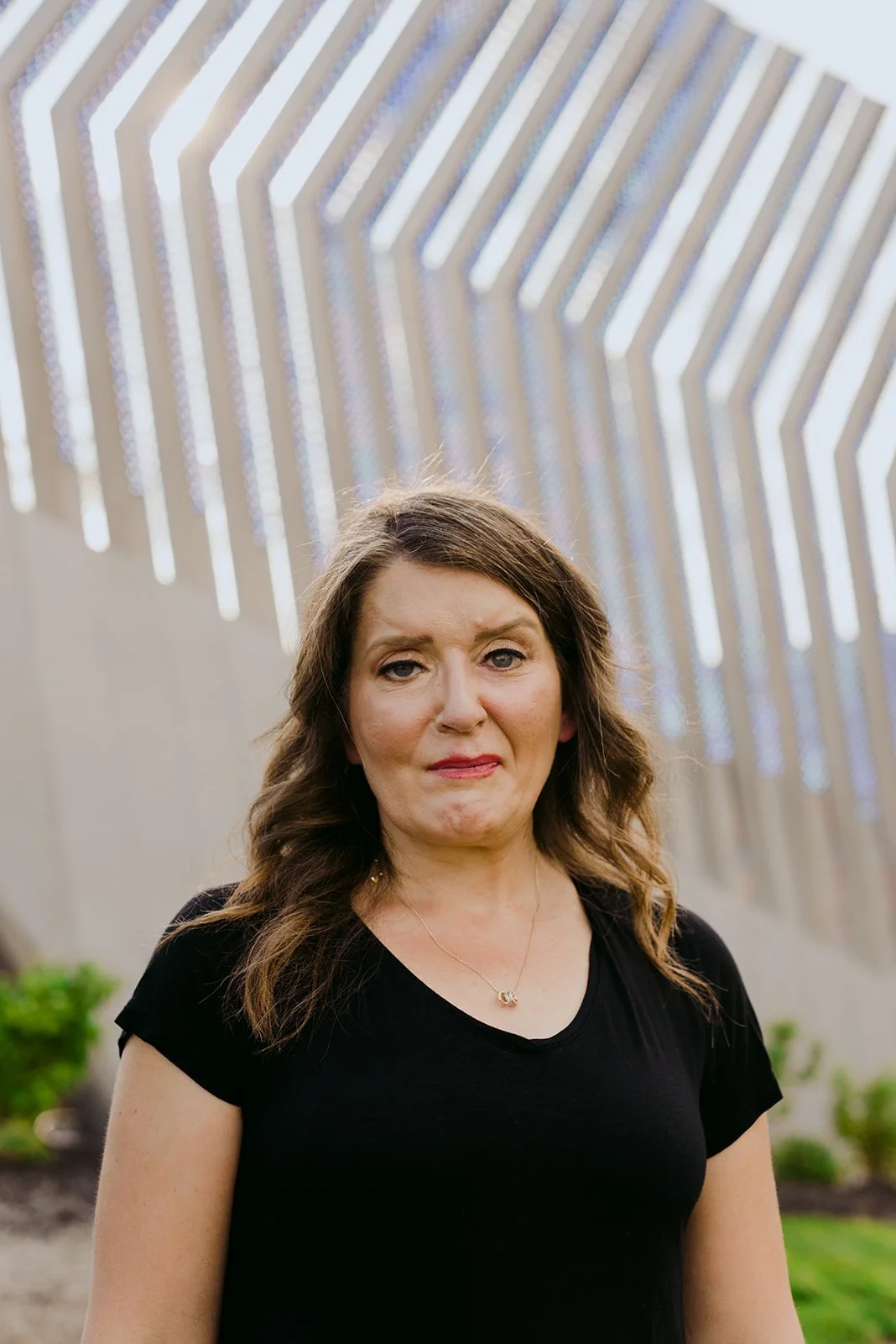 Portrait of Marie-Claire McKelvey standing outdoors, reflecting the strength, resilience, and compassion that inspire her writing and advocacy.