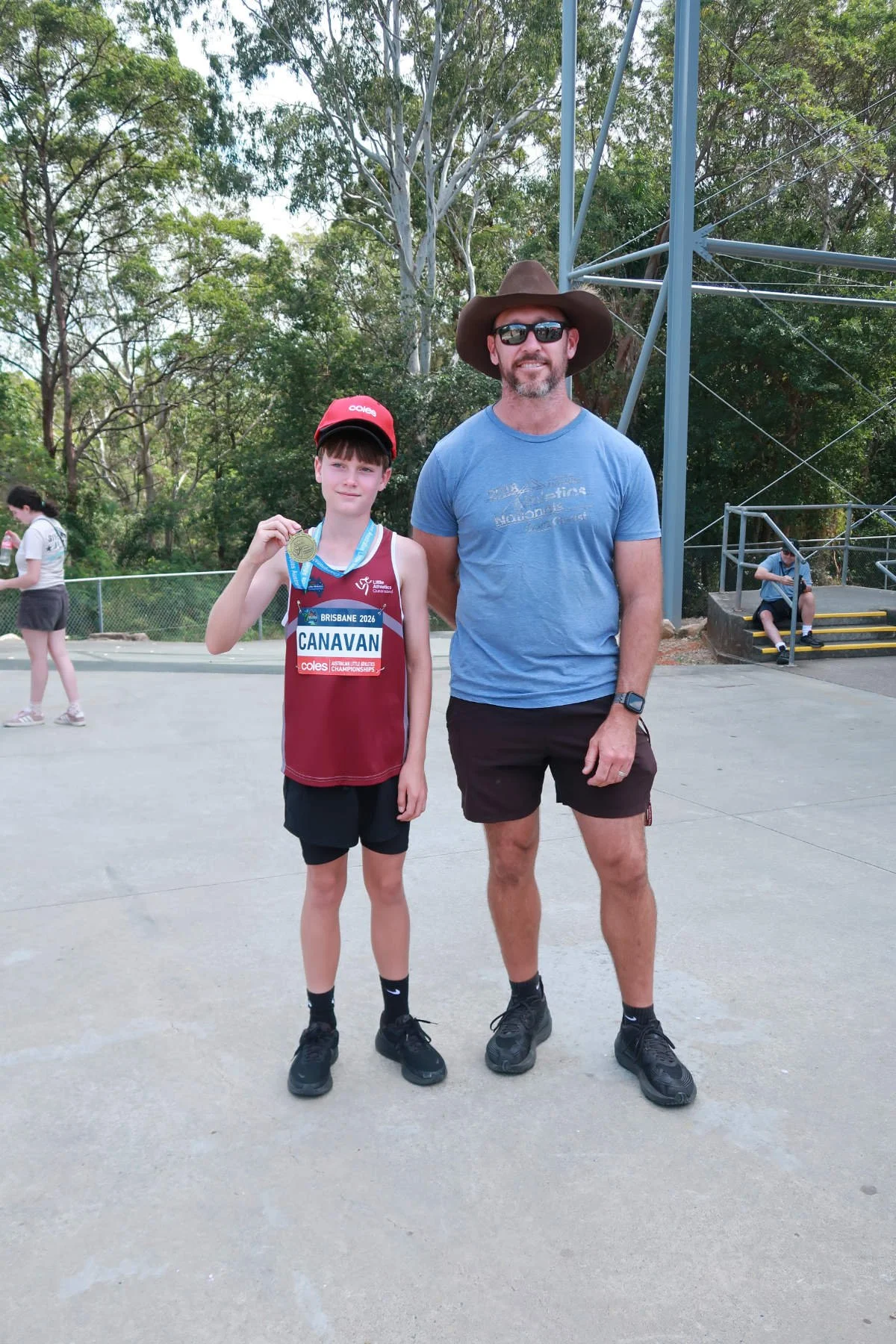 Ormeau Little Athletics - ALAC nationals athlete with coach and medal
