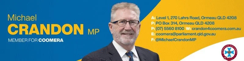A political campaign banner for Michael Crandon MP from the Coomera area. It features his name, photo, and contact information, with a blue and yellow background and the Queensland Police badge in the bottom right corner.