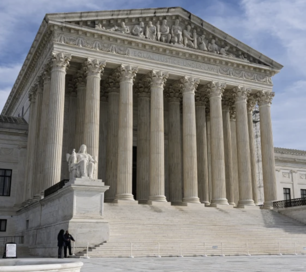 Front view of the United States Supreme Court building with large Corinthian columns, steps, and classical sculptures.