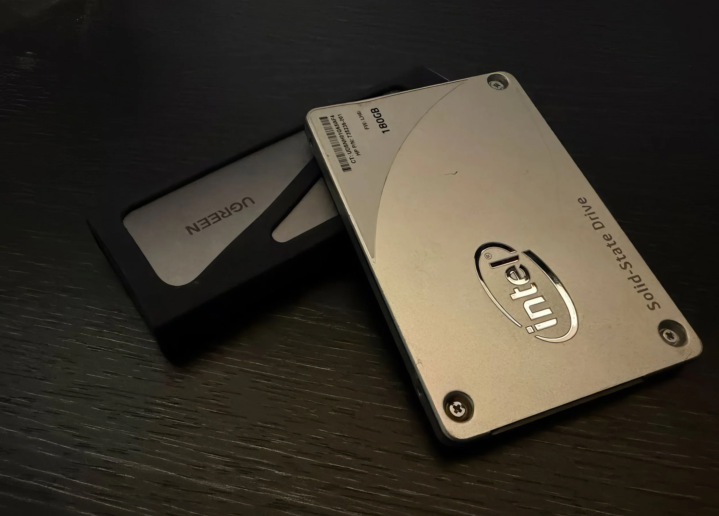 Close-up of an Intel solid-state drive (SSD) on a dark surface.