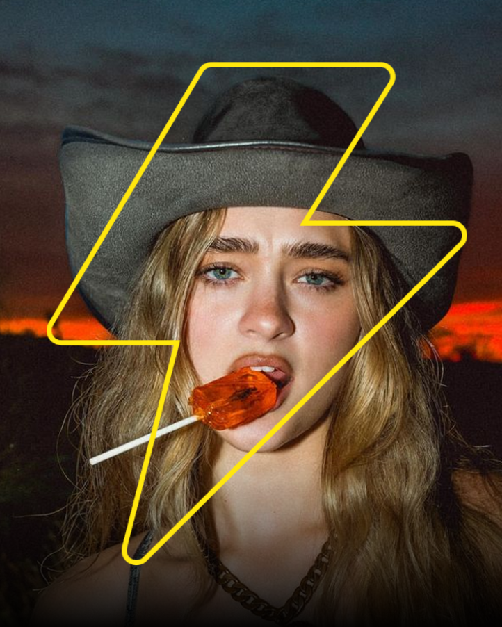 Young woman with blonde hair and blue eyes wearing a gray cowboy hat, holding an orange popsicle in her mouth, with a sunset sky and dark clouds in the background, outlined by a yellow lightning bolt.