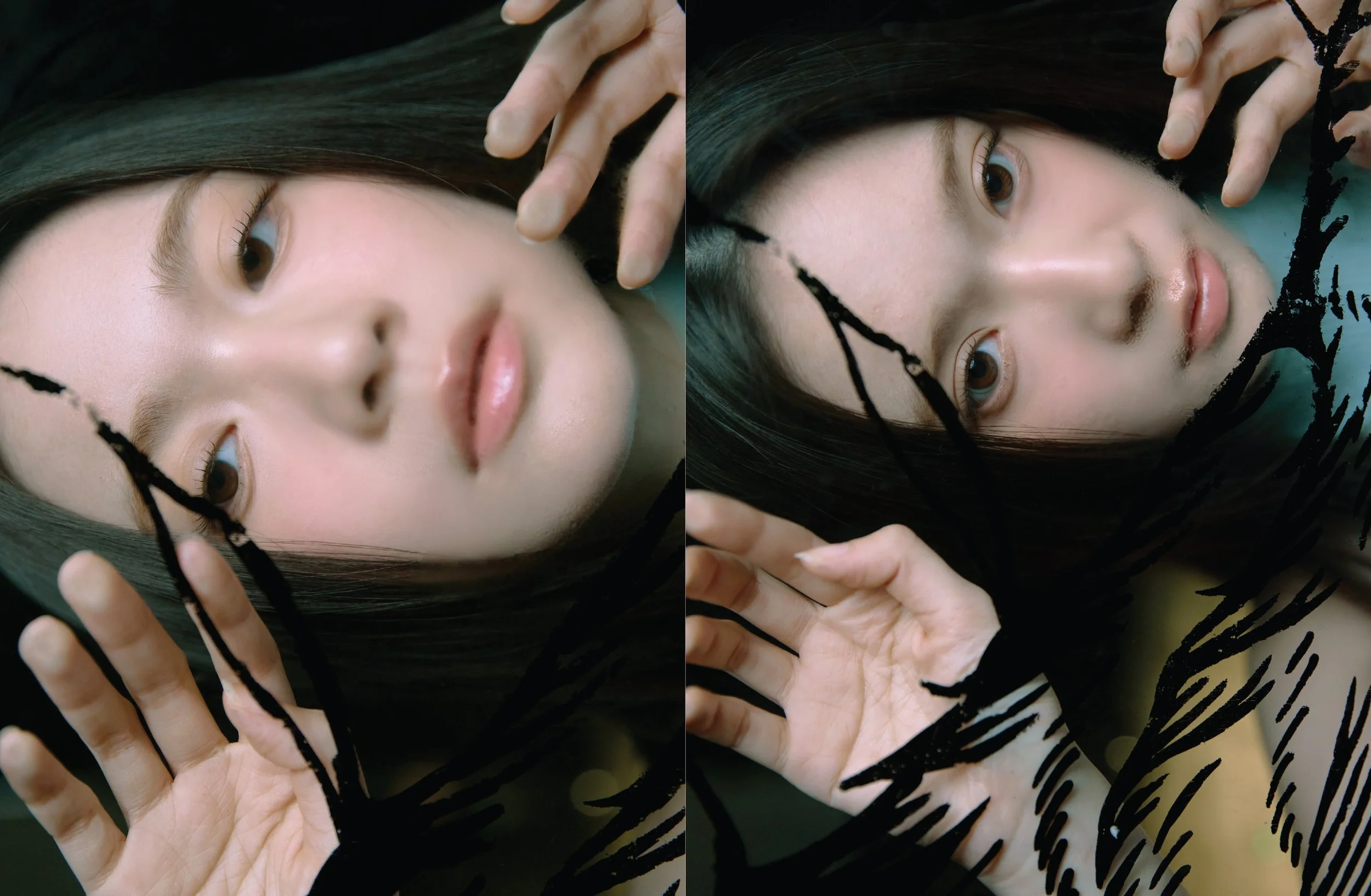 Cloud wan, Close-up of a woman's face lying down with her hand near her head, and black paint streaks across her face and hand, with a dark background.