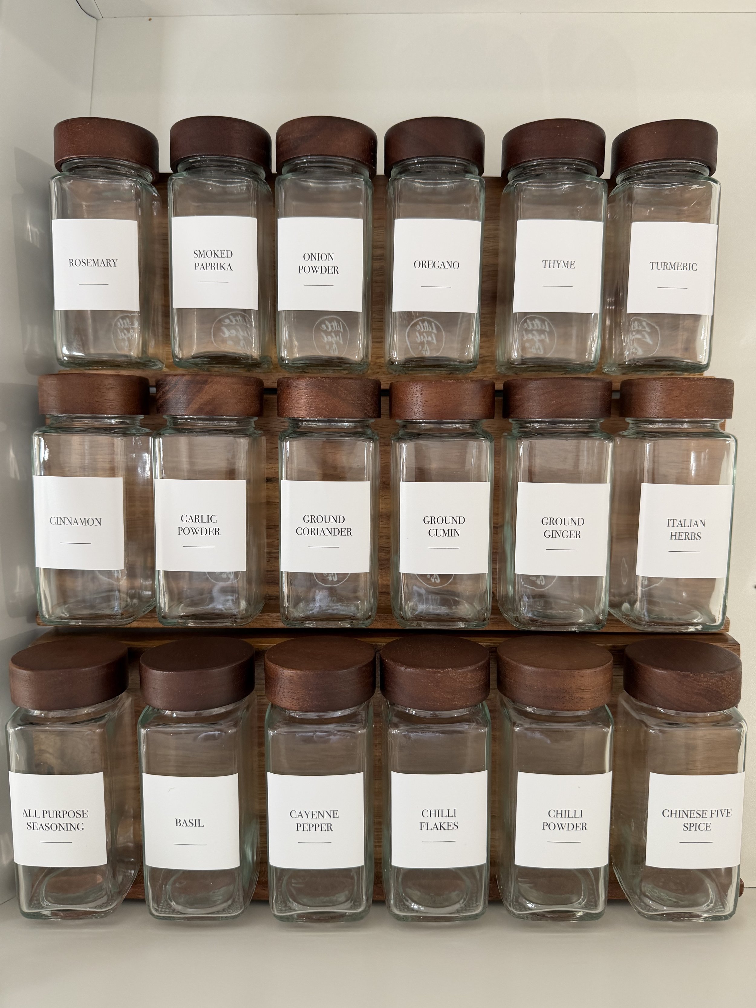 Labelled glass spice jars arranged in neat rows in the Spring Creek Residence kitchen