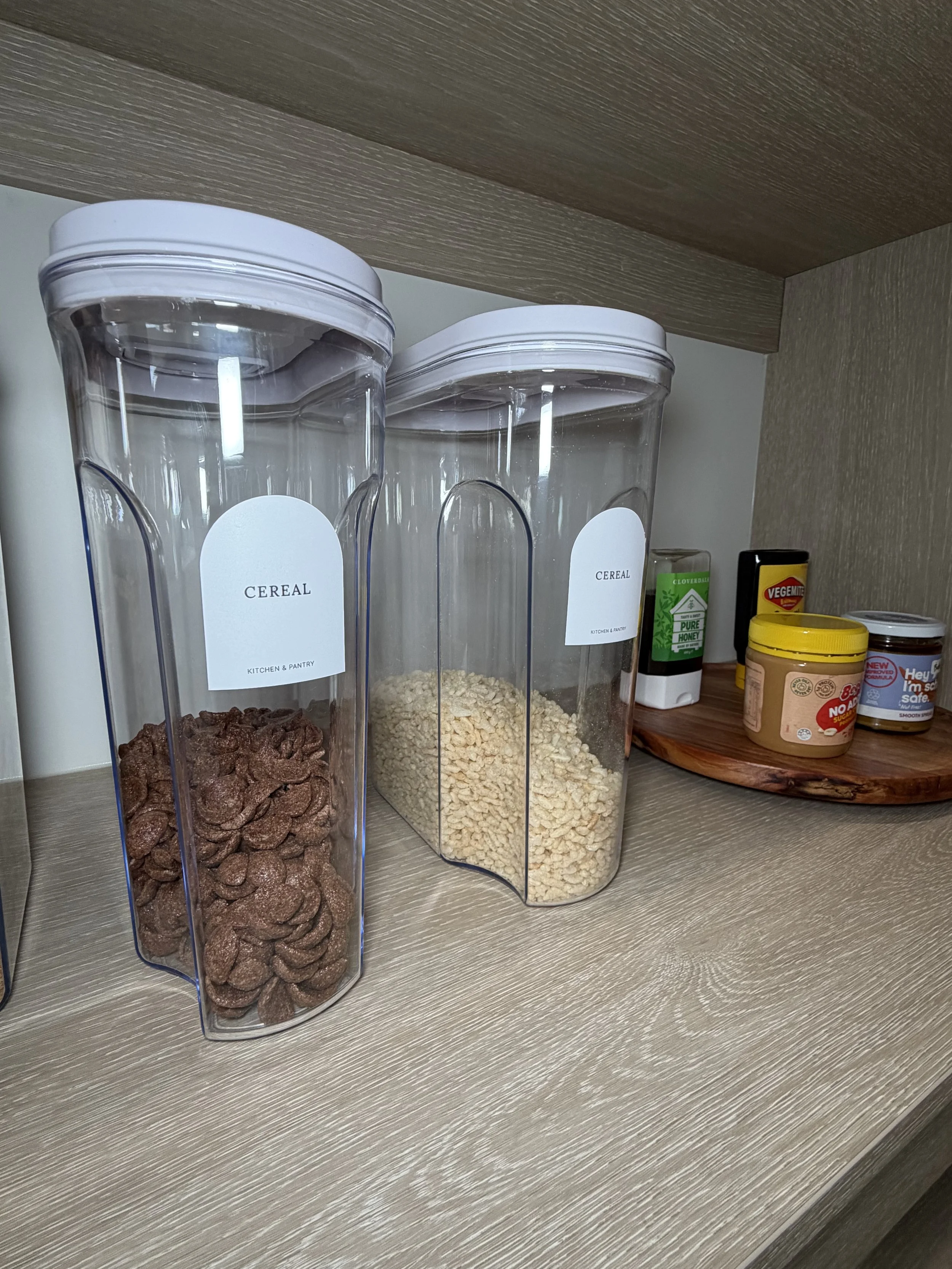 Clear labelled canisters of decanted cereal and grains in the Spring Creek Residence pantry