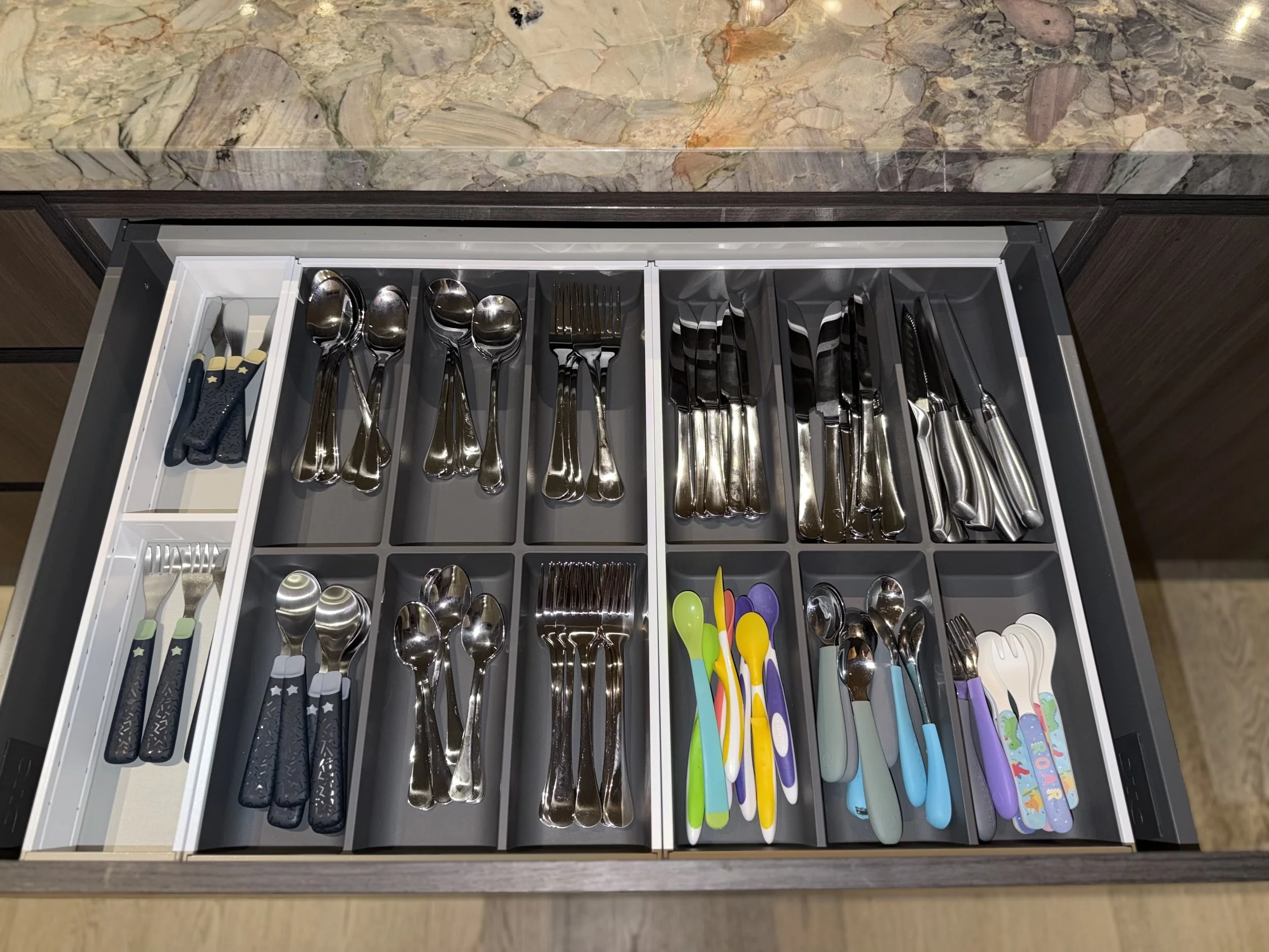 Cutlery organised in fitted timber drawer dividers