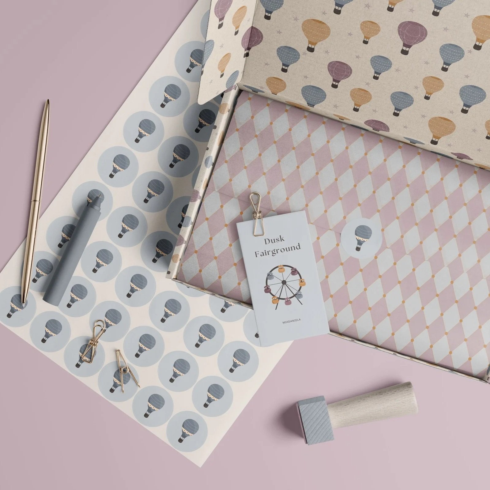 Premium paper goods mockup showcasing coordinated surface pattern designs from the Dusk Fairground collection.