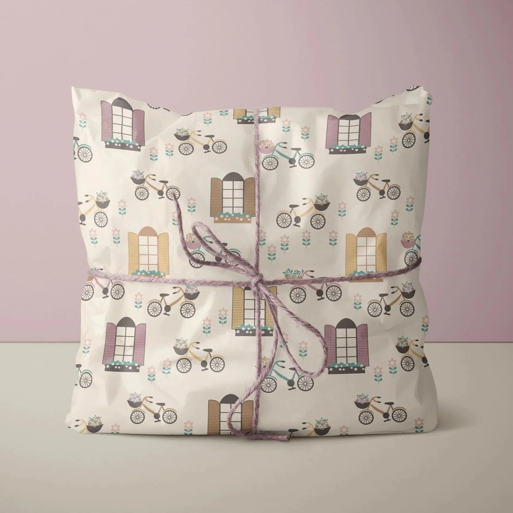 Gift wrapping mockup featuring the Love Lives Here collection with illustrated houses, bicycles and coordinating patterns for premium gift presentation.