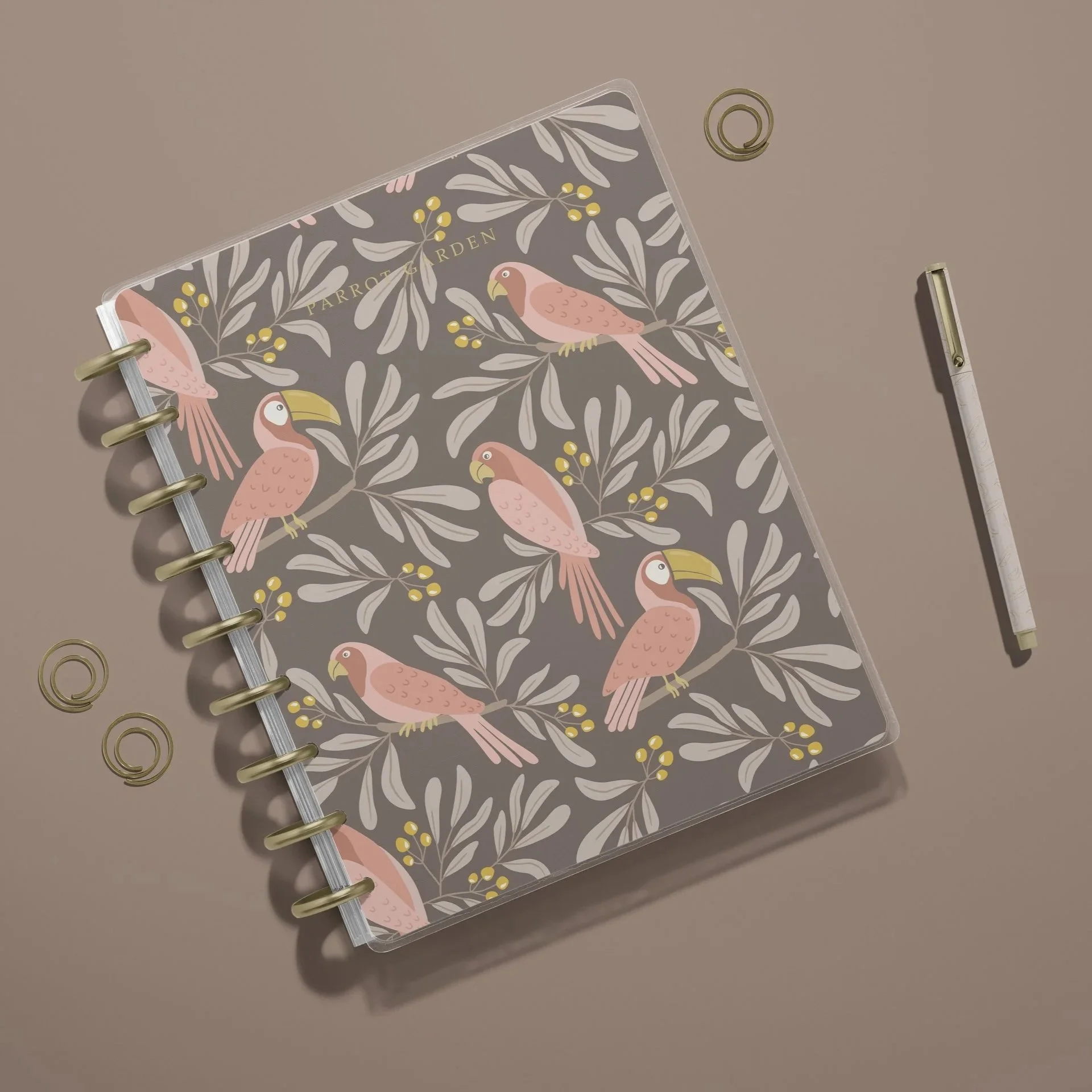 Notebook mockup featuring the Parrot Garden collection in the Cocoa Brown colorway with coordinating botanical surface pattern designs.