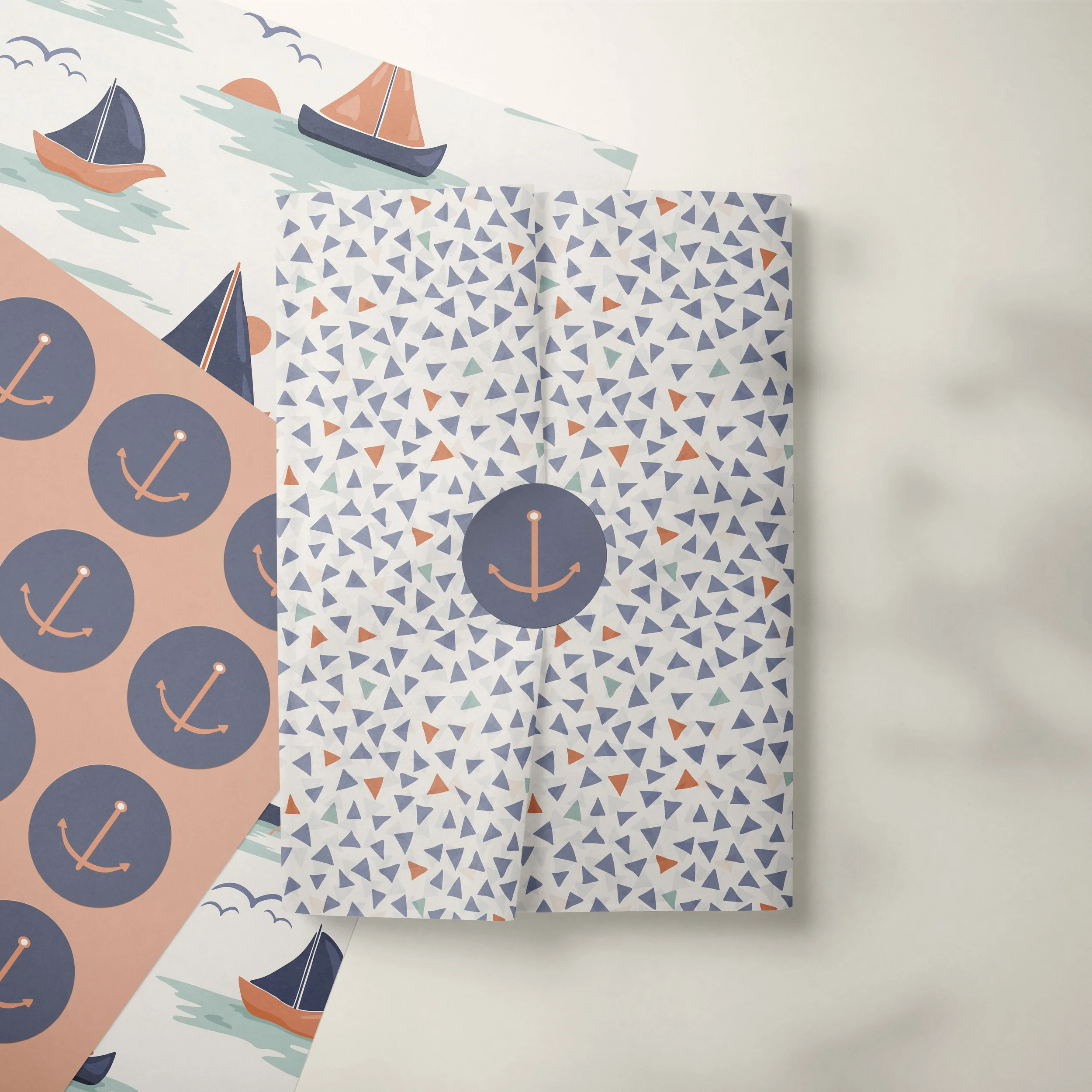 Tissue paper and sticker sheets mockup featuring the Dusk Sailing collection designed for gift packaging, boutique retail presentation and coordinated paper goods.