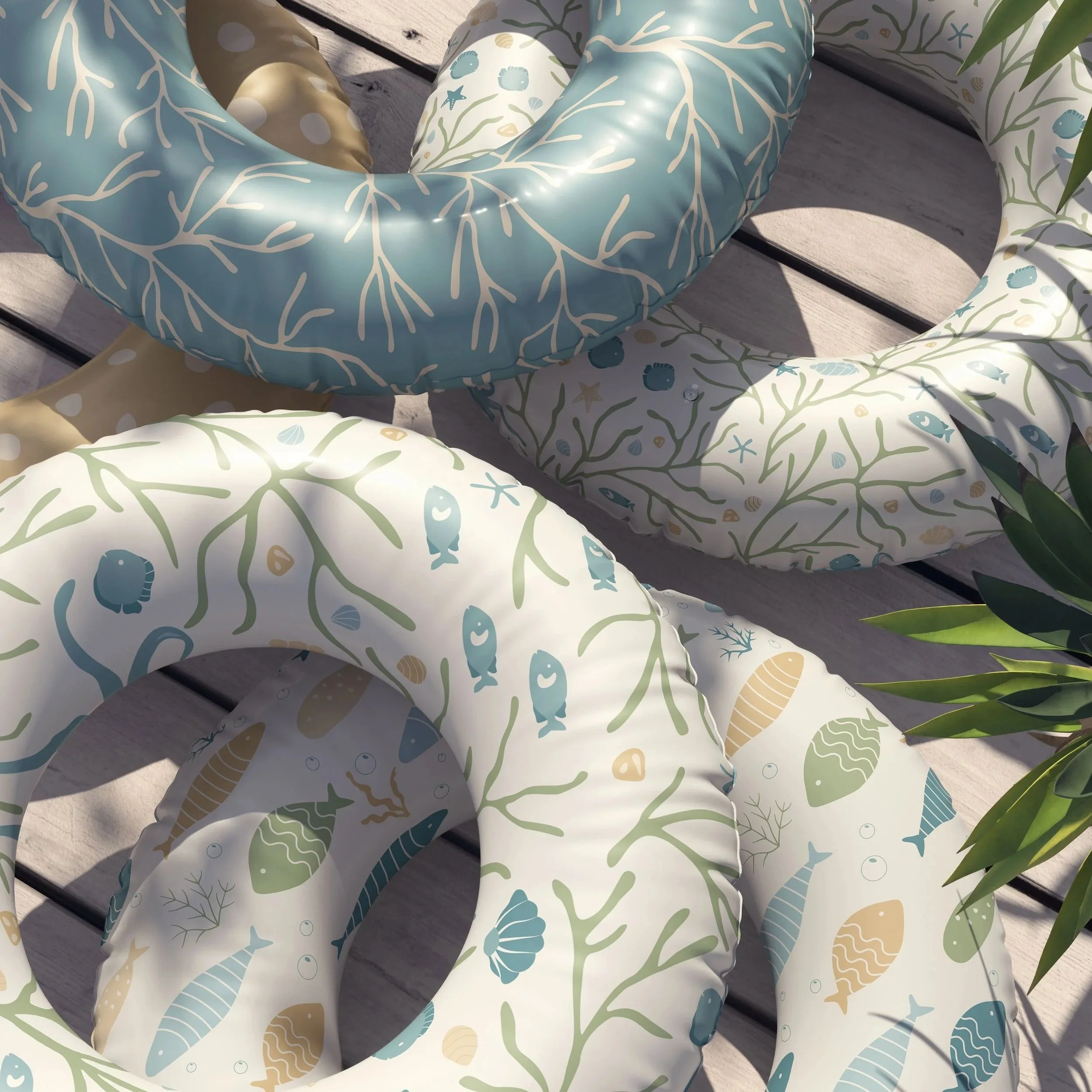 Outdoor lifestyle mockup featuring the Coastal Coral Reef collection in the Seafoam Calm colorway applied to pool floats and beach accessories.