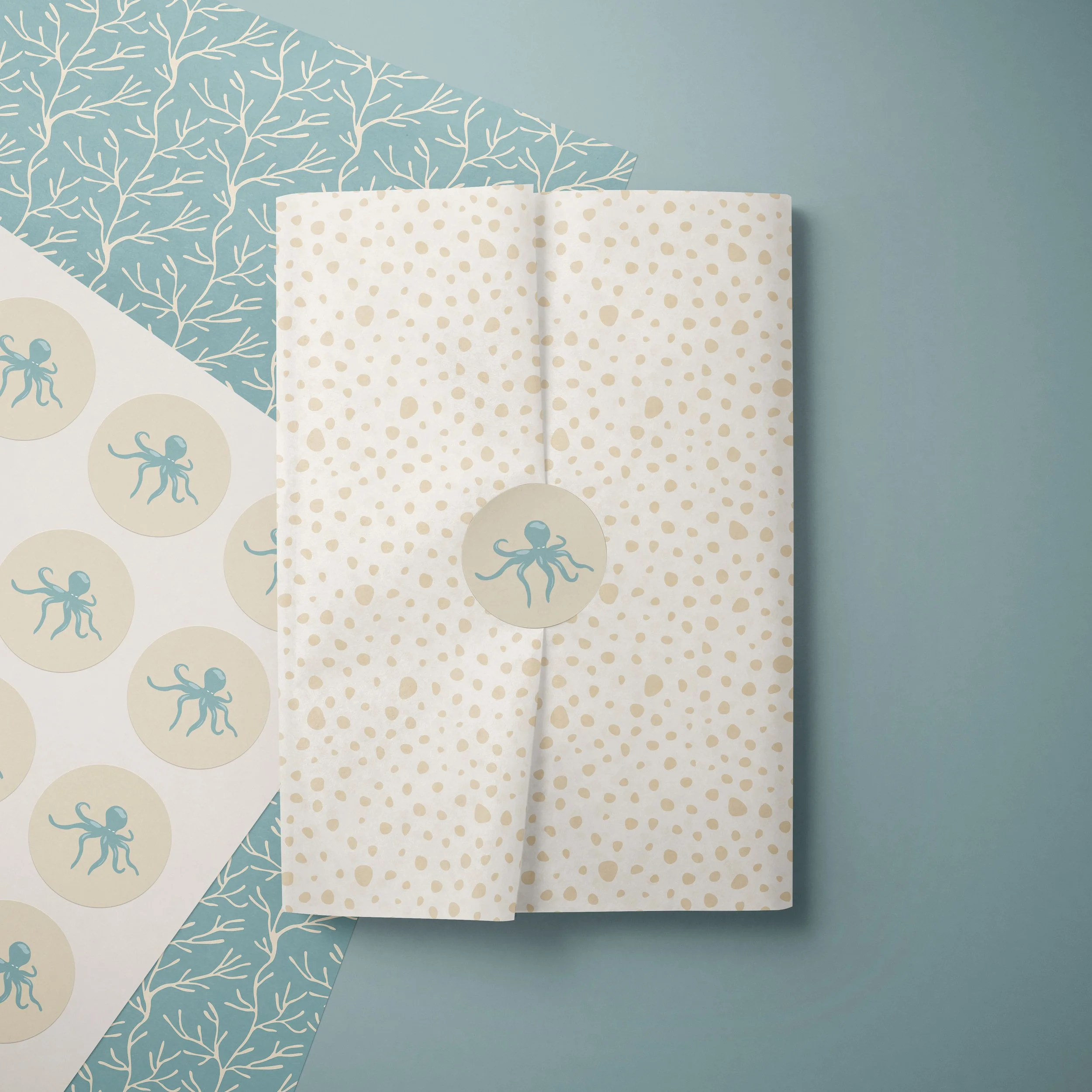 Tissue paper and sticker sheets mockup featuring the Coastal Coral Reef collection in the Seafoam Calm colorway .