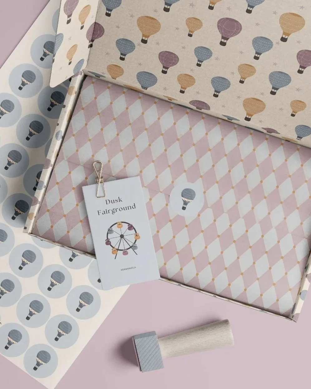 Packaging mockup showcasing coordinated surface pattern designs from the Dusk Fairground collection.