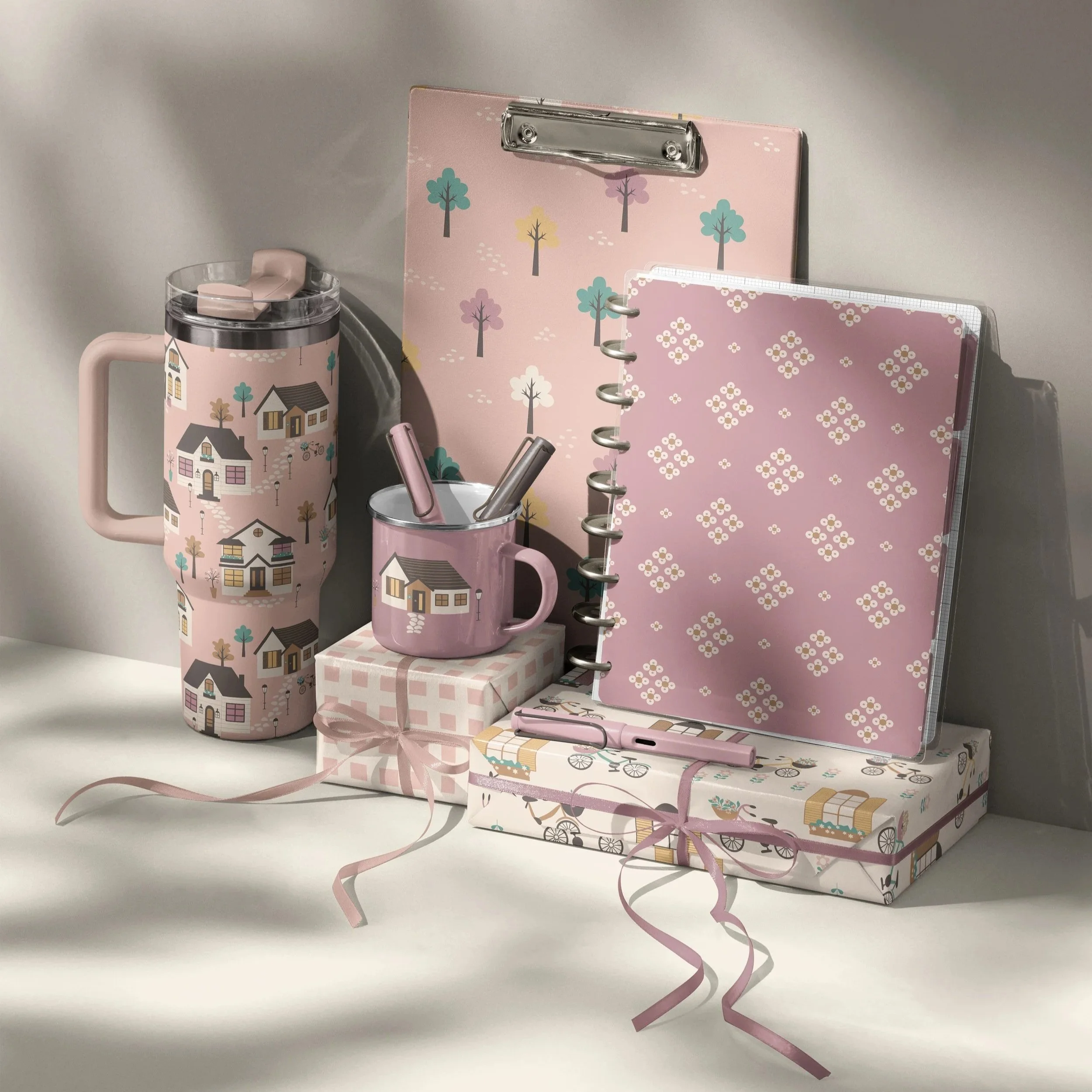 Stationery collection mockup featuring the Love Lives Here surface pattern collection applied to planners, notebooks, drinkware and coordinated desk accessories.