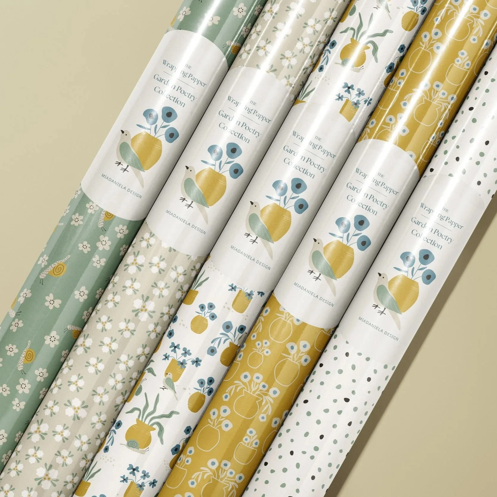 Wrapping paper collection featuring coordinated Garden Poetry floral surface patterns designed for gift wrap and boutique packaging.