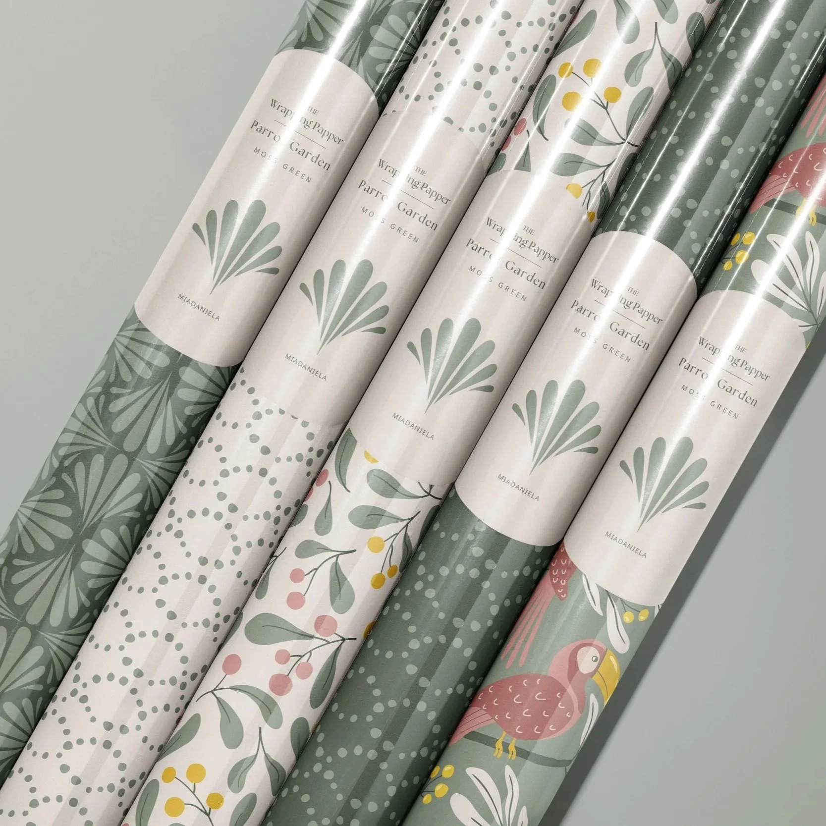 Wrapping paper collection featuring coordinated botanical surface pattern designs from the Parrot Garden collection in the Moss Green colorway.