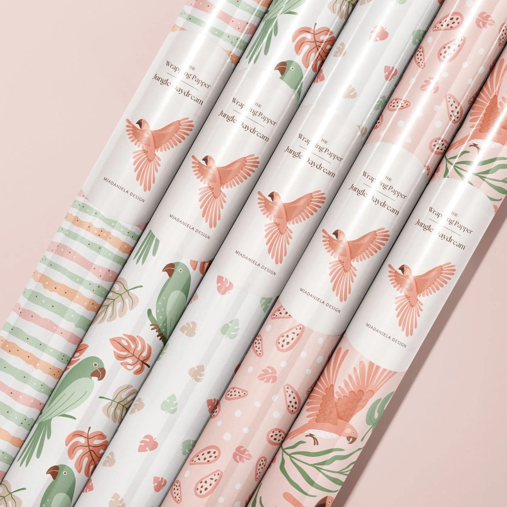 Gift wrap mockup showcasing coordinated tropical birds and botanical surface pattern designs from the Jungle Daydream collection.