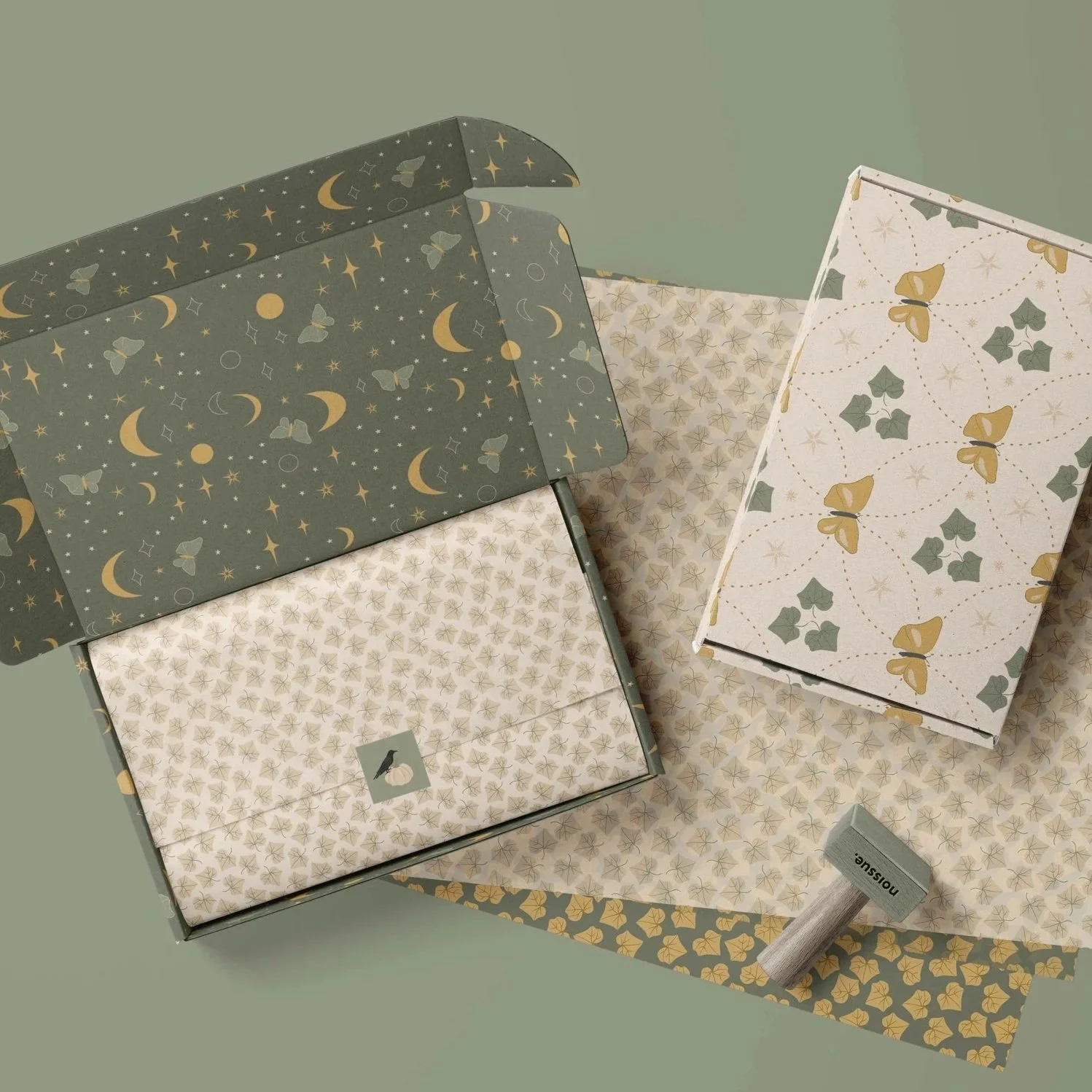Premium packaging mockup featuring coordinated surface pattern designs from The Midnight Society collection applied to gift boxes and boutique paper goods.