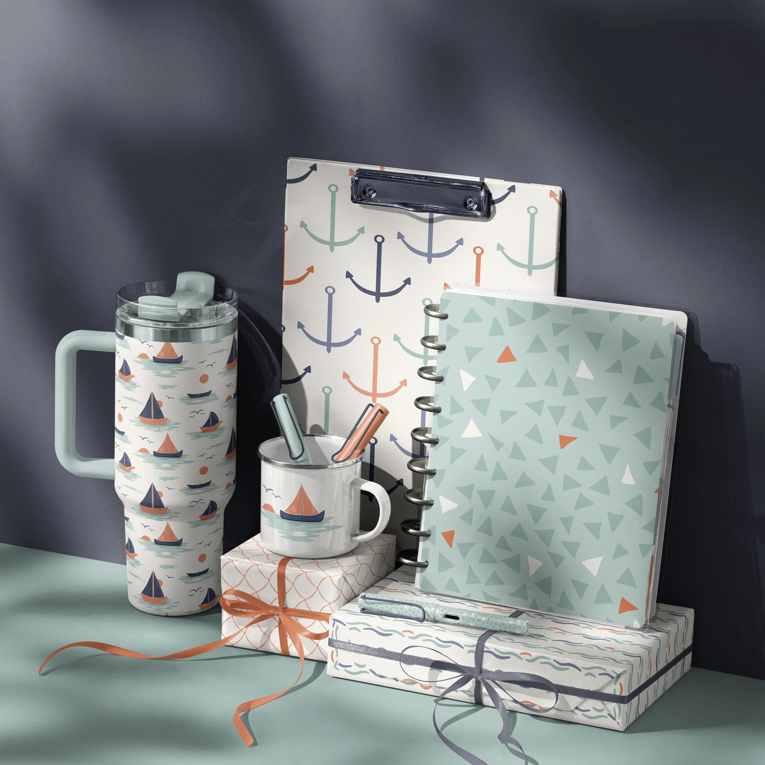 Stationery collection mockup featuring the Dusk Sailing surface pattern collection applied to planners, notebooks, drinkware and coordinated desk accessories.