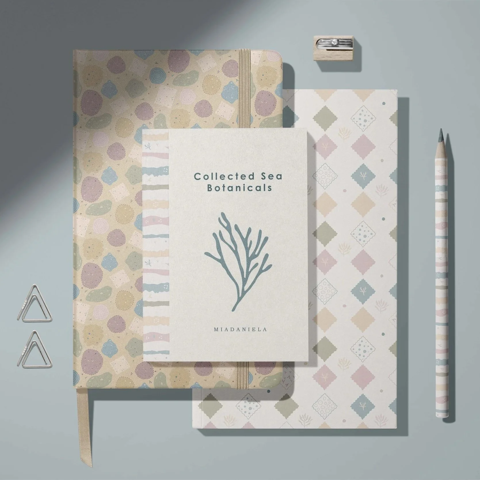 Stationery collection mockup featuring notebooks, planners and coordinated desk accessories with the Collected Sea Botanicals patterns.